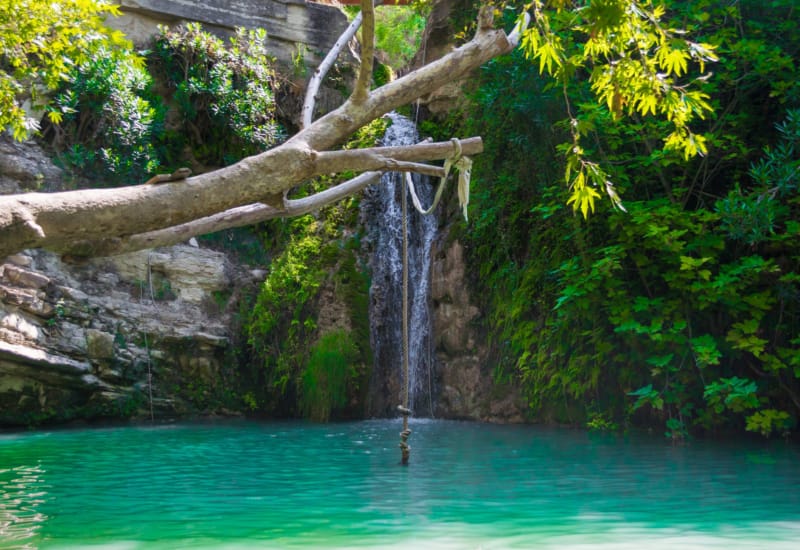 a waterfall over a pool of water