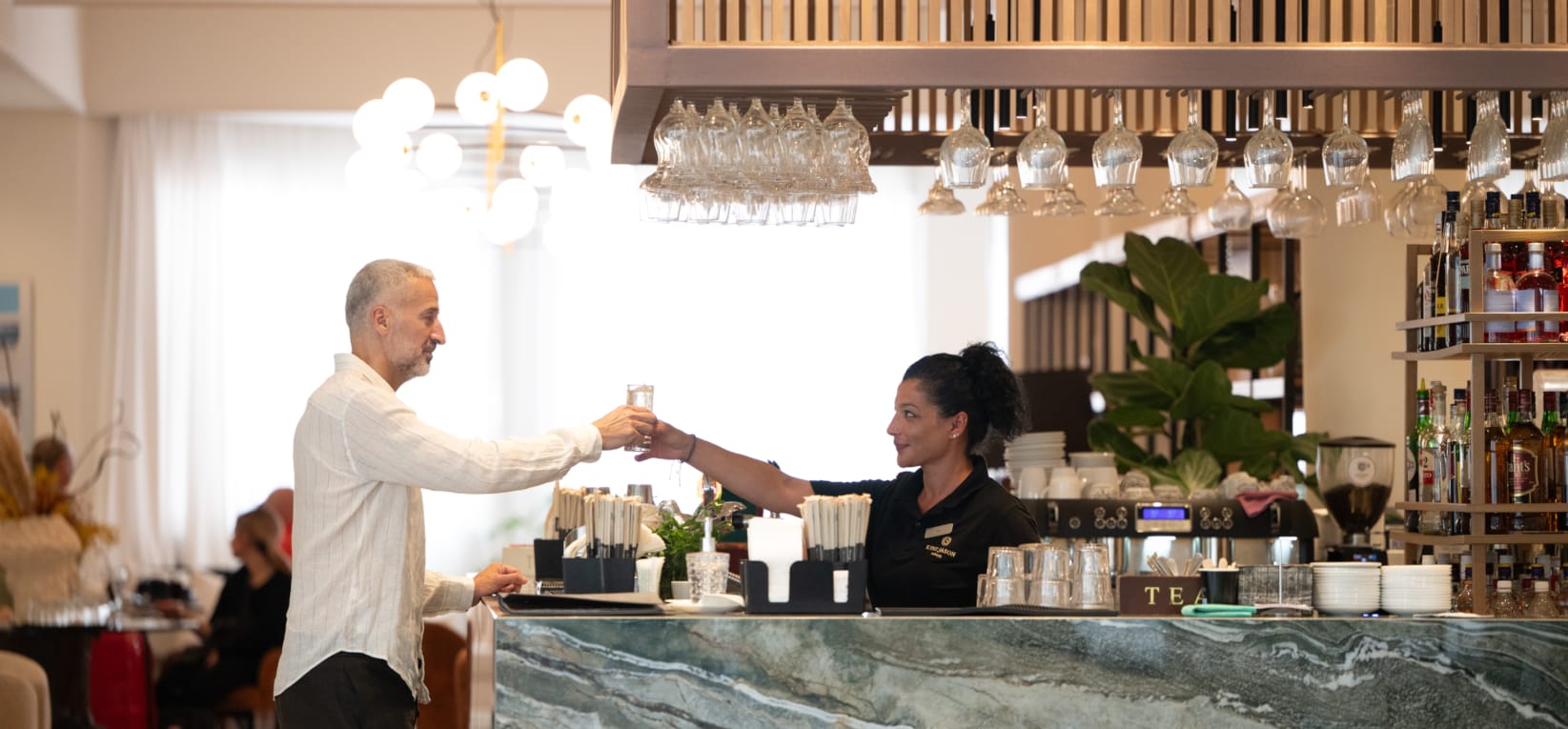 a man and a woman in a room with a large table