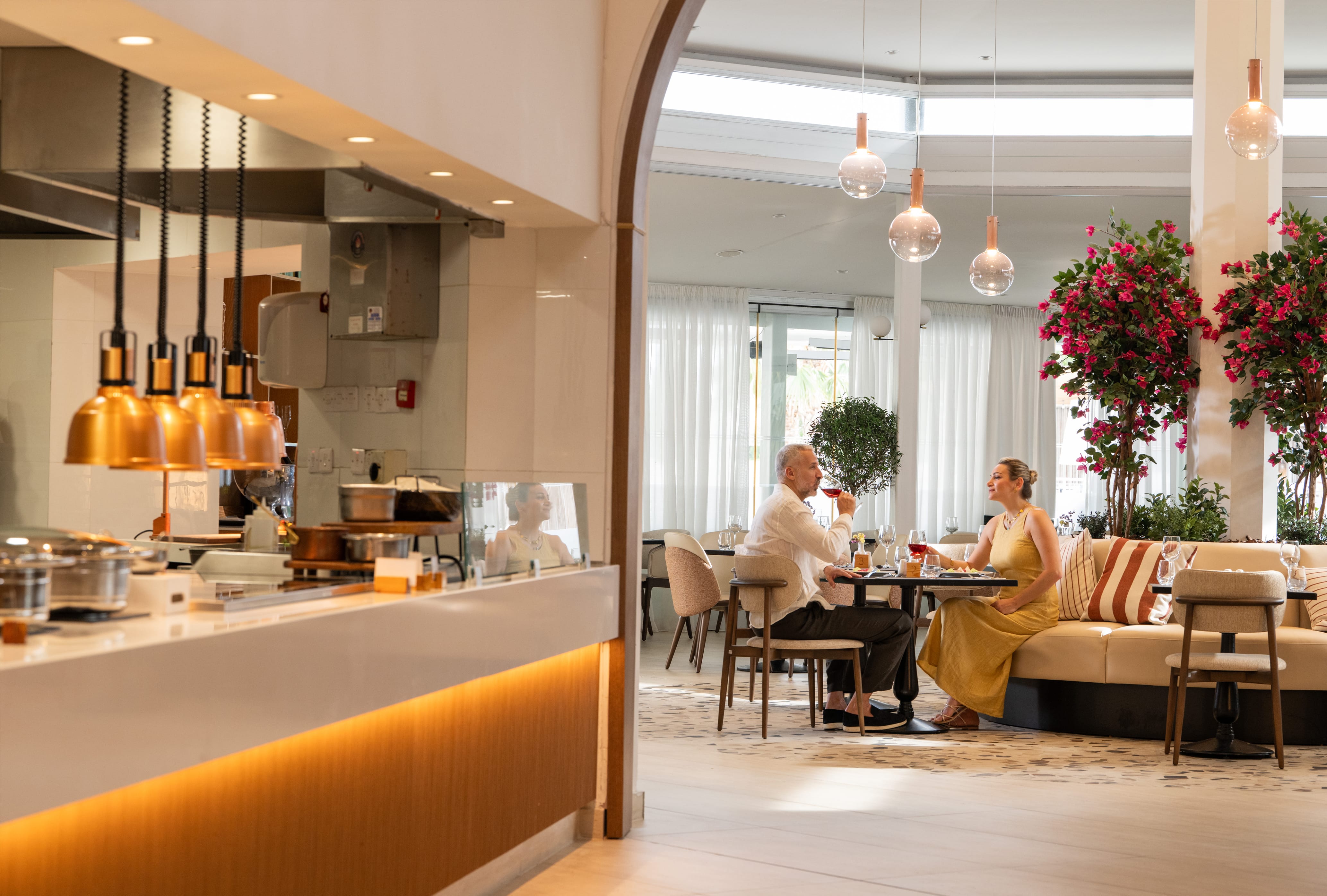 a couple of people sitting at a table in a restaurant