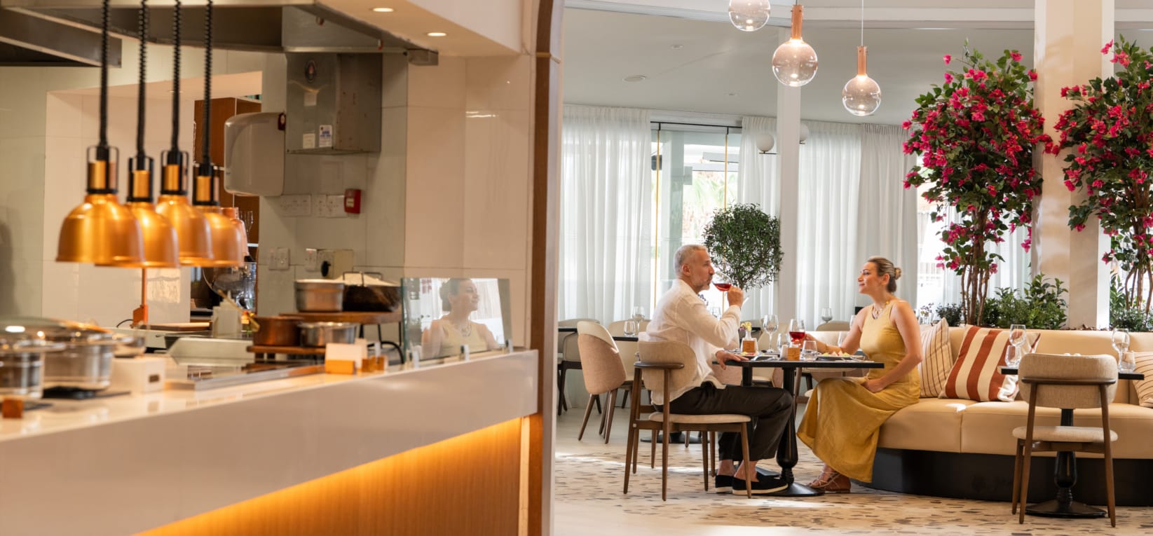 a couple of people sitting at a table in a restaurant