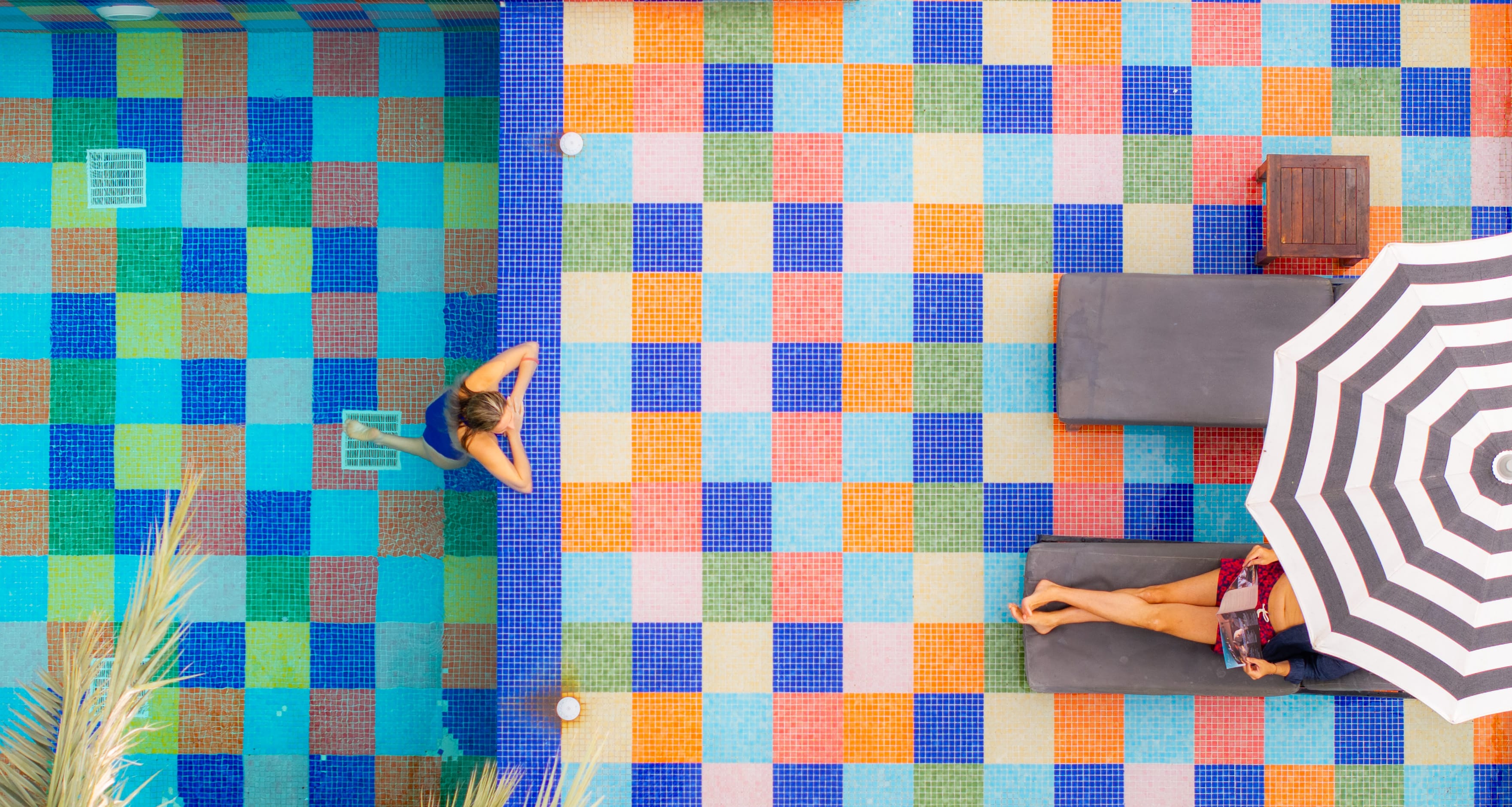 a person standing in front of a colorful wall