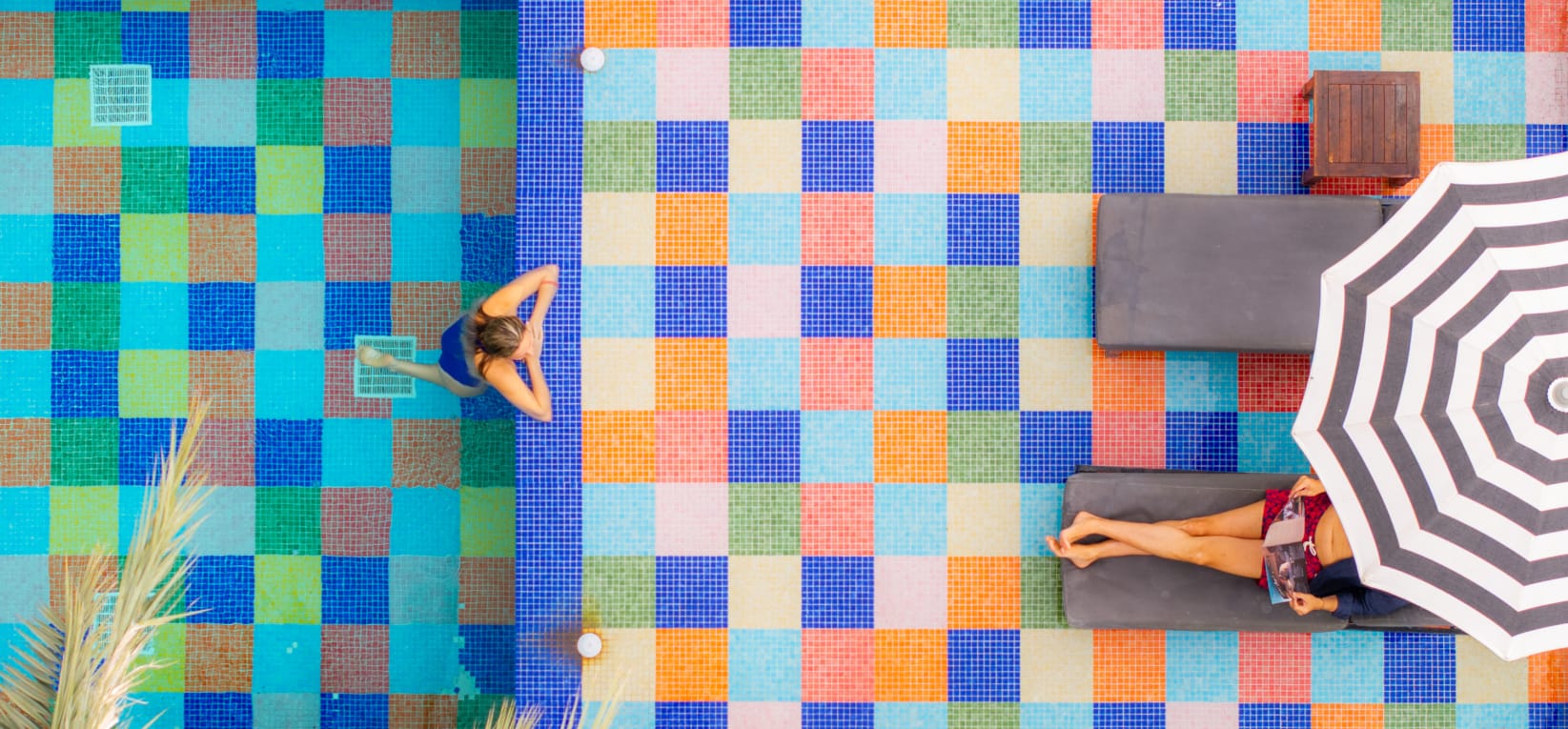 a person standing in front of a colorful wall