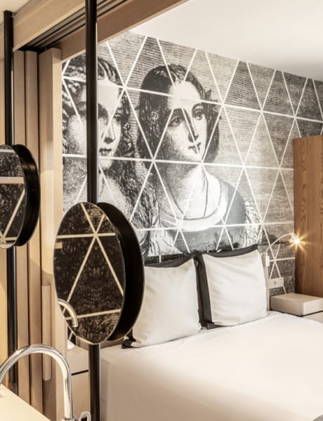 a bed with a painting on the wall