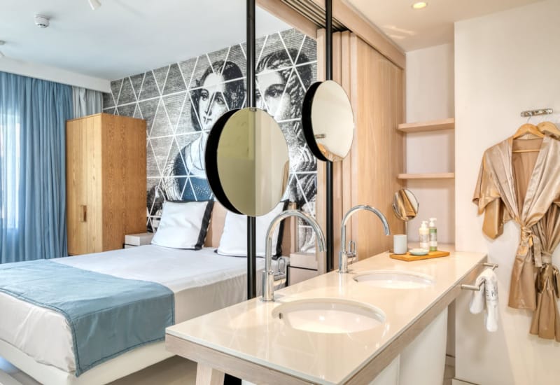 a bathroom with a bed and a sink