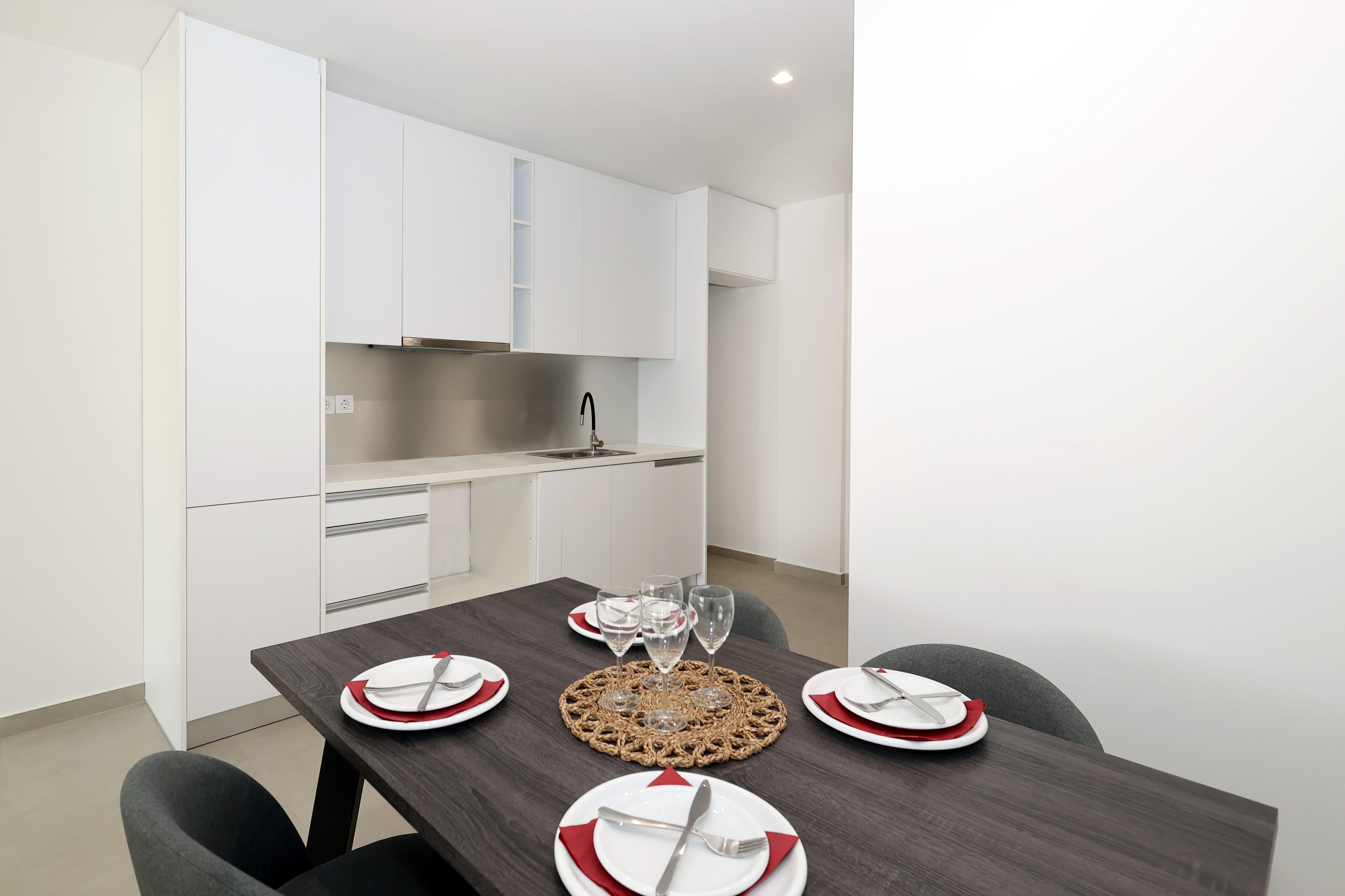 a kitchen with plates and glasses on a table