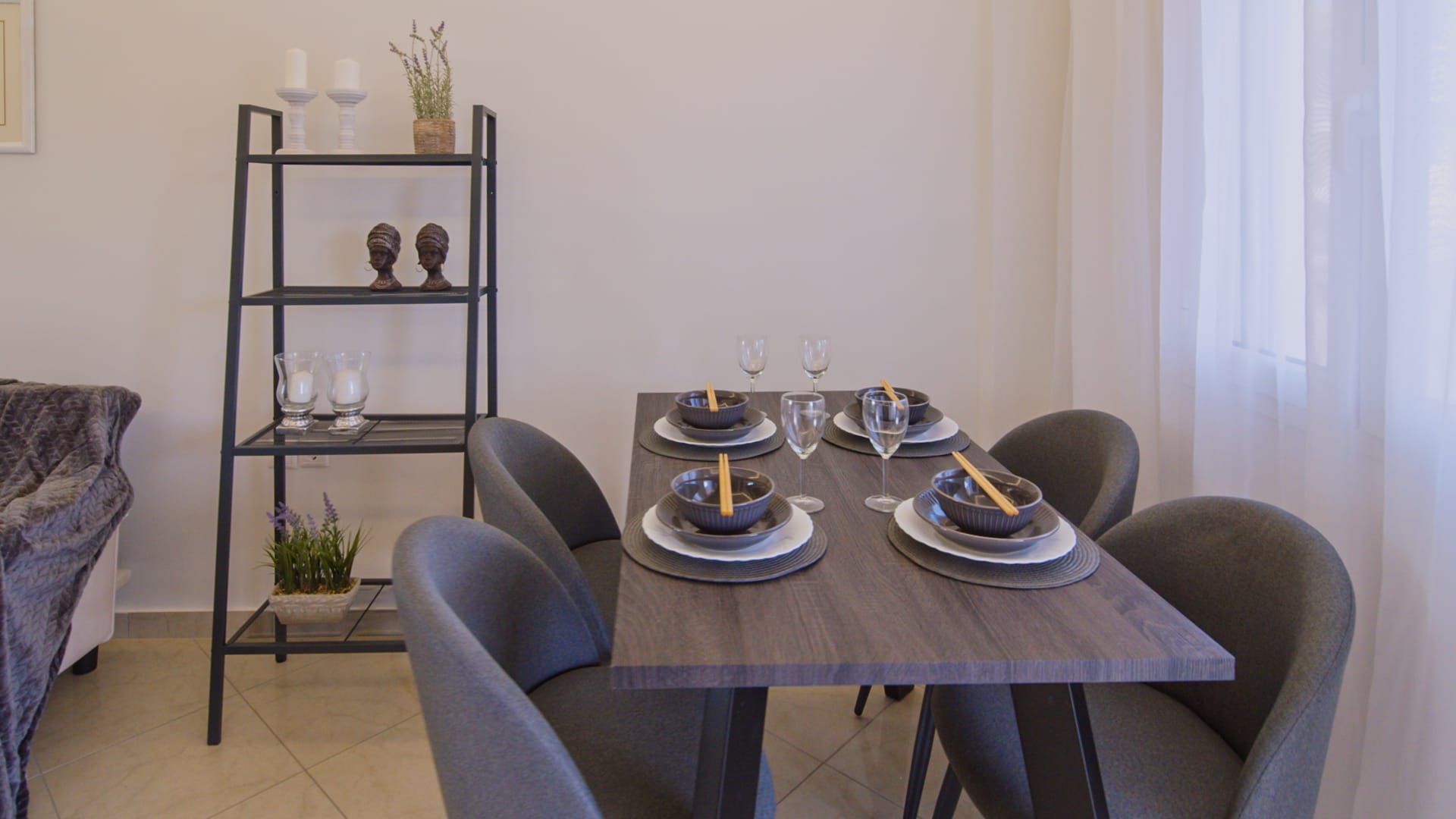 a dining table with plates and glasses on it