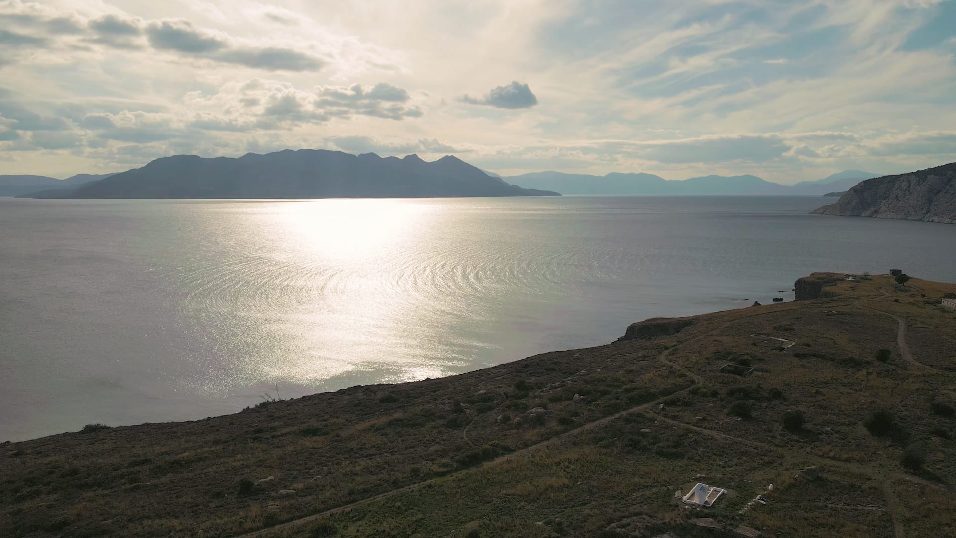 a body of water with hills around it