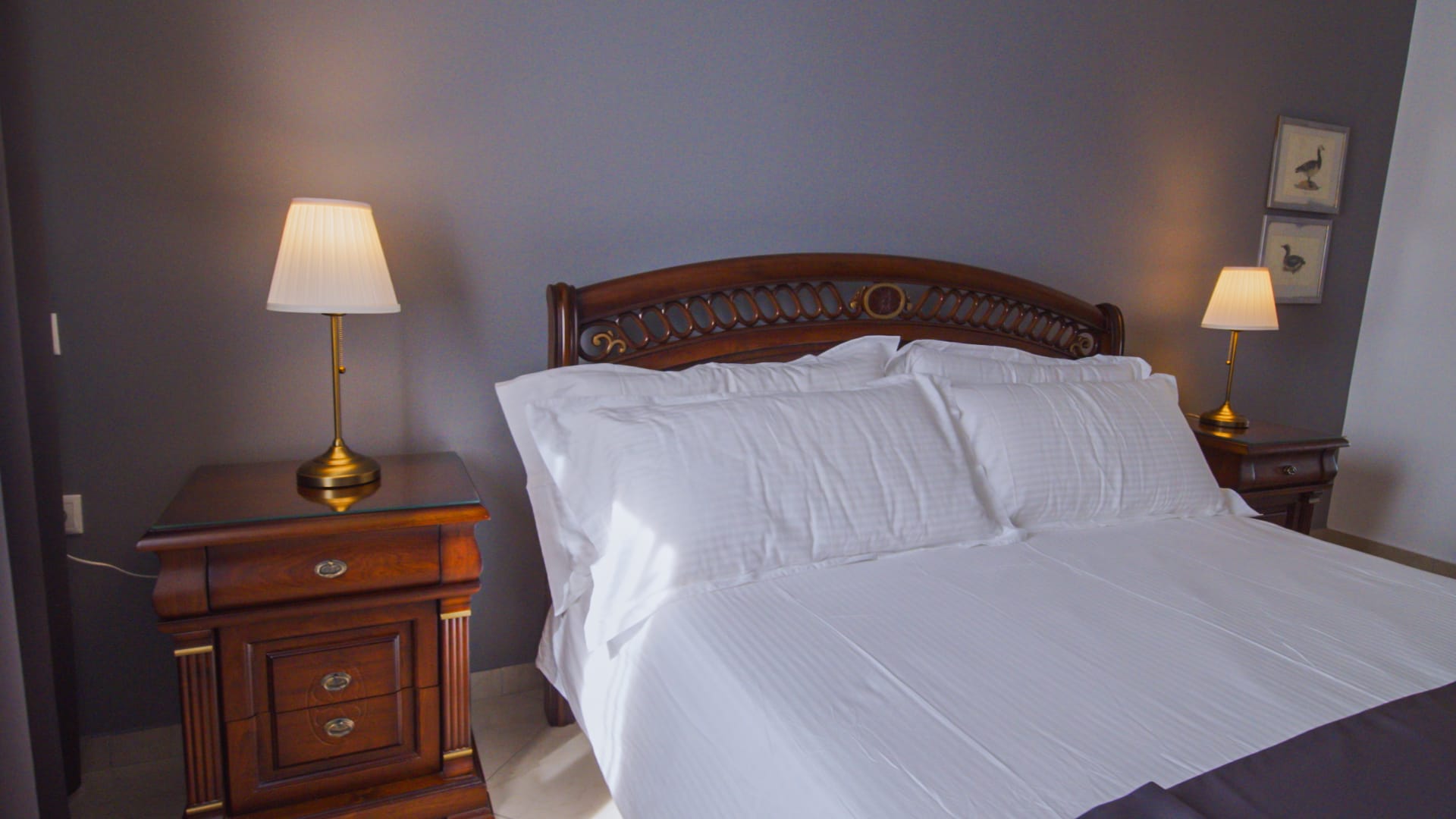 a bed with lamps on either side