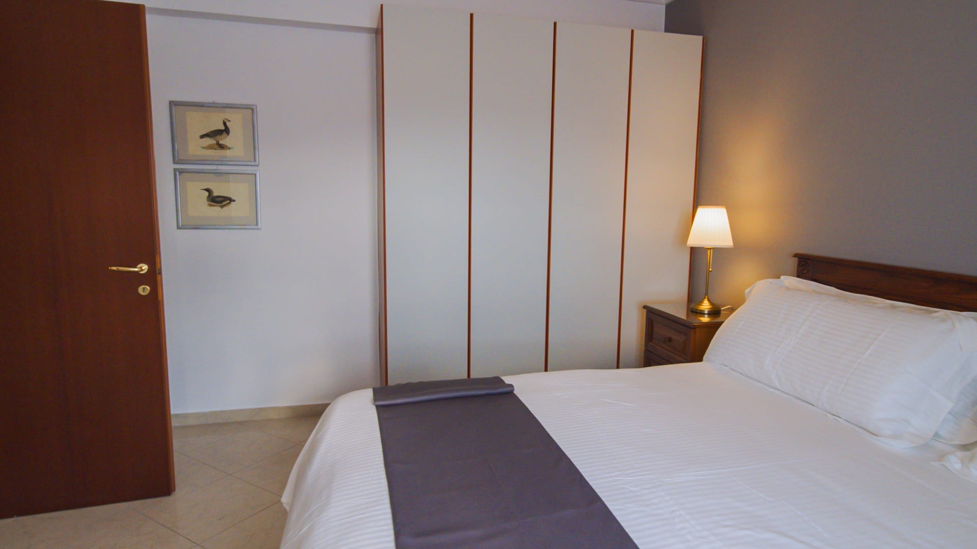 a room with a bed and a lamp