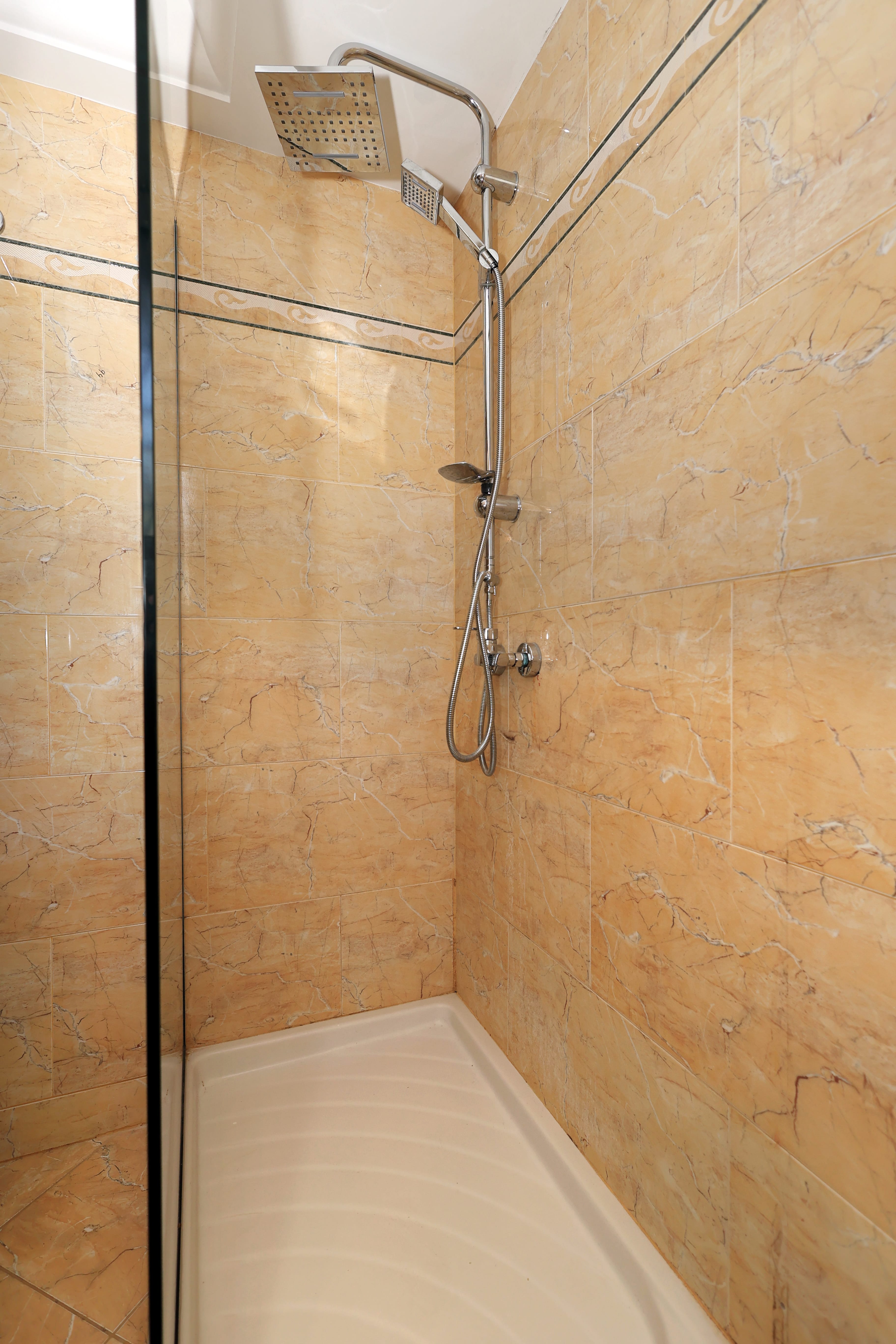 a shower with a metal bar