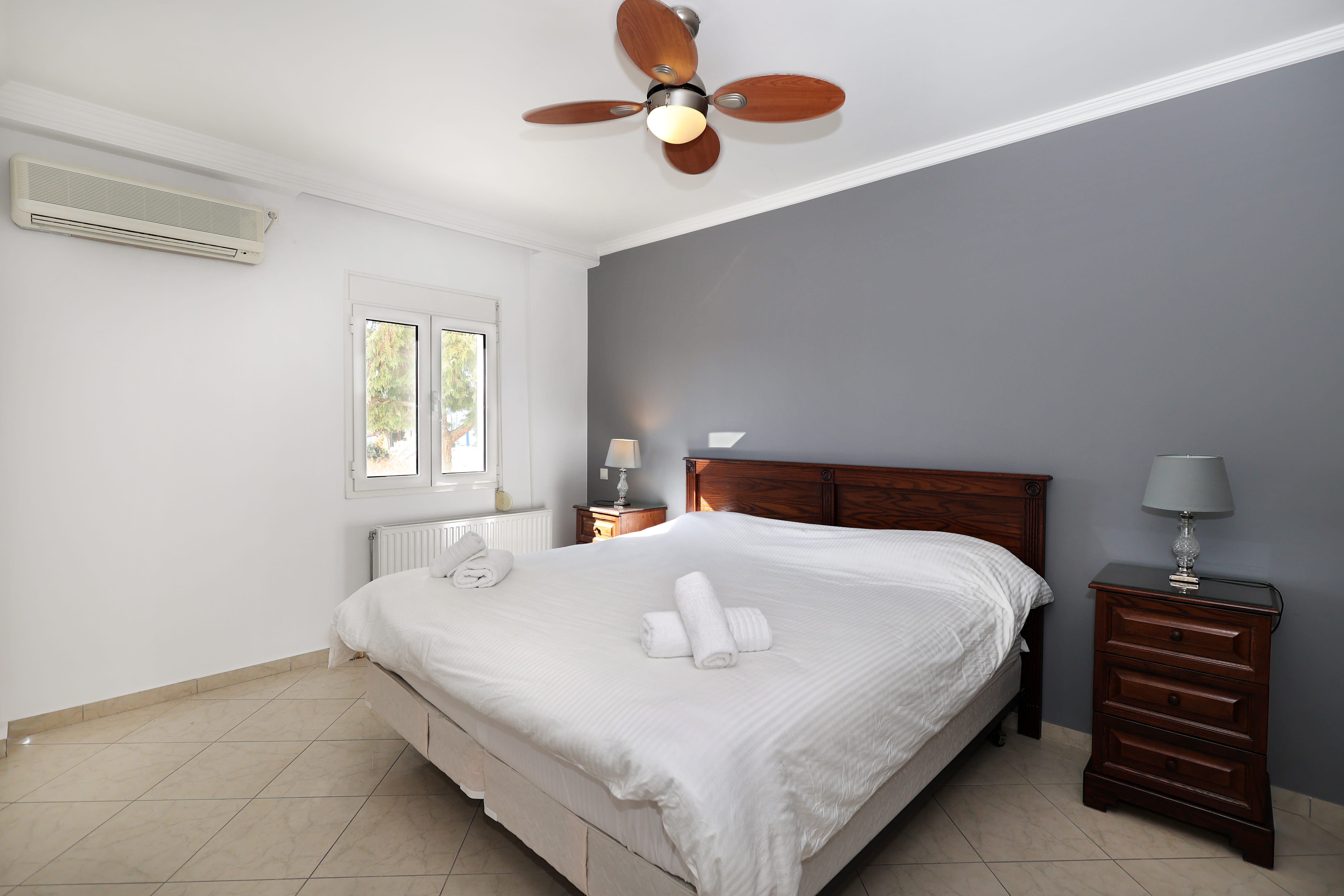 a bedroom with a bed and a fan