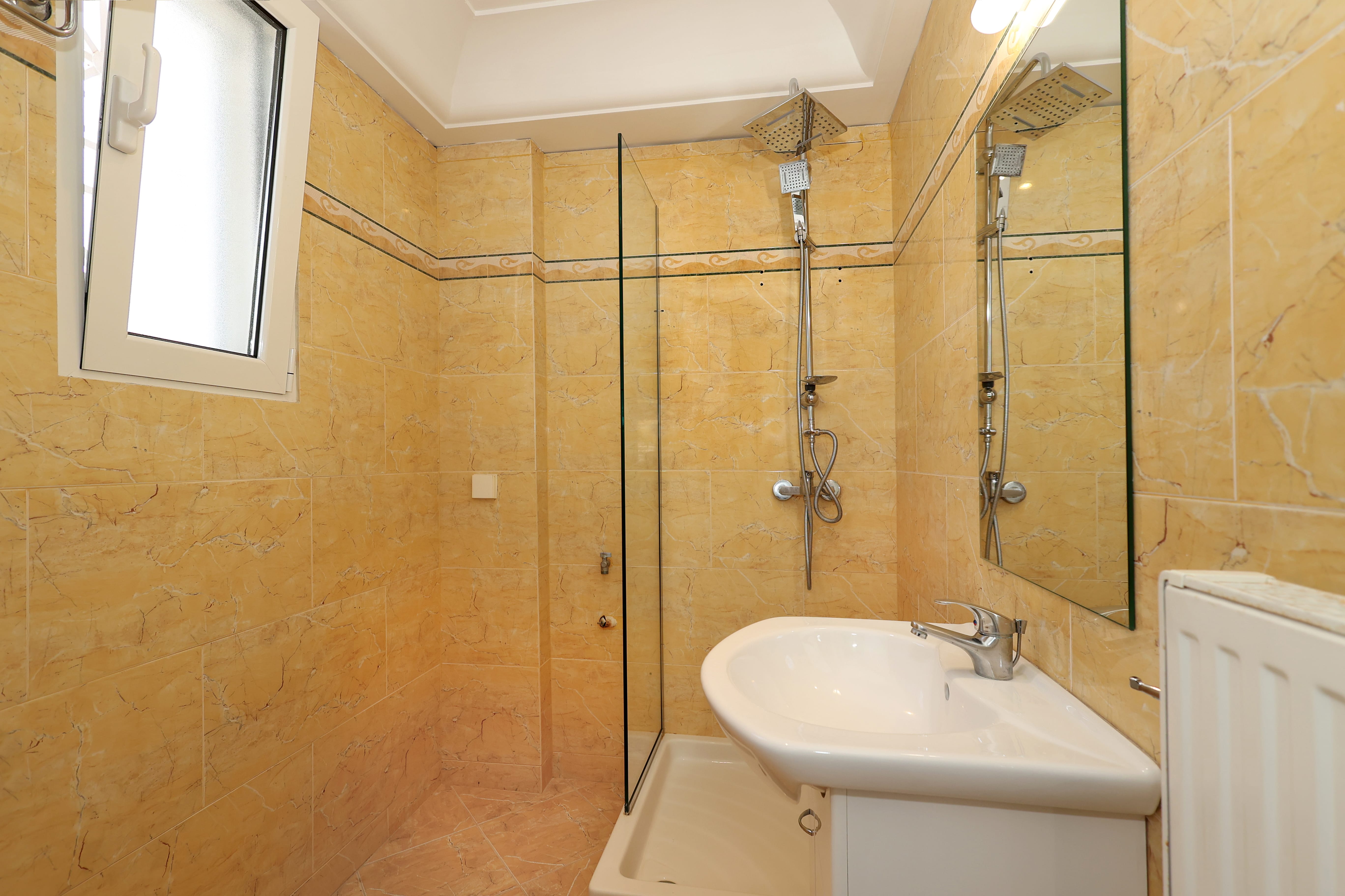 a bathroom with a sink and a shower unit