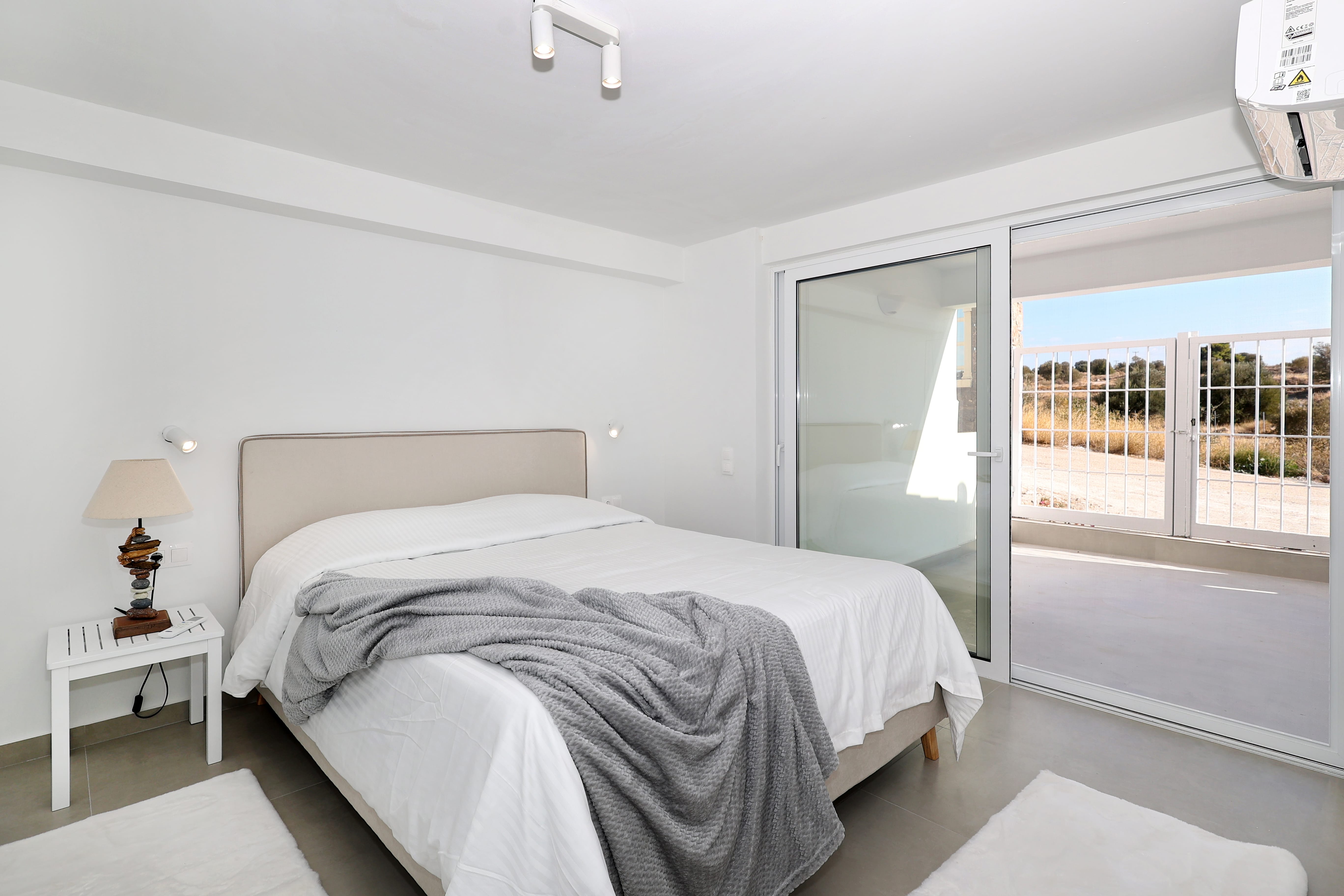 a bedroom with a large glass door