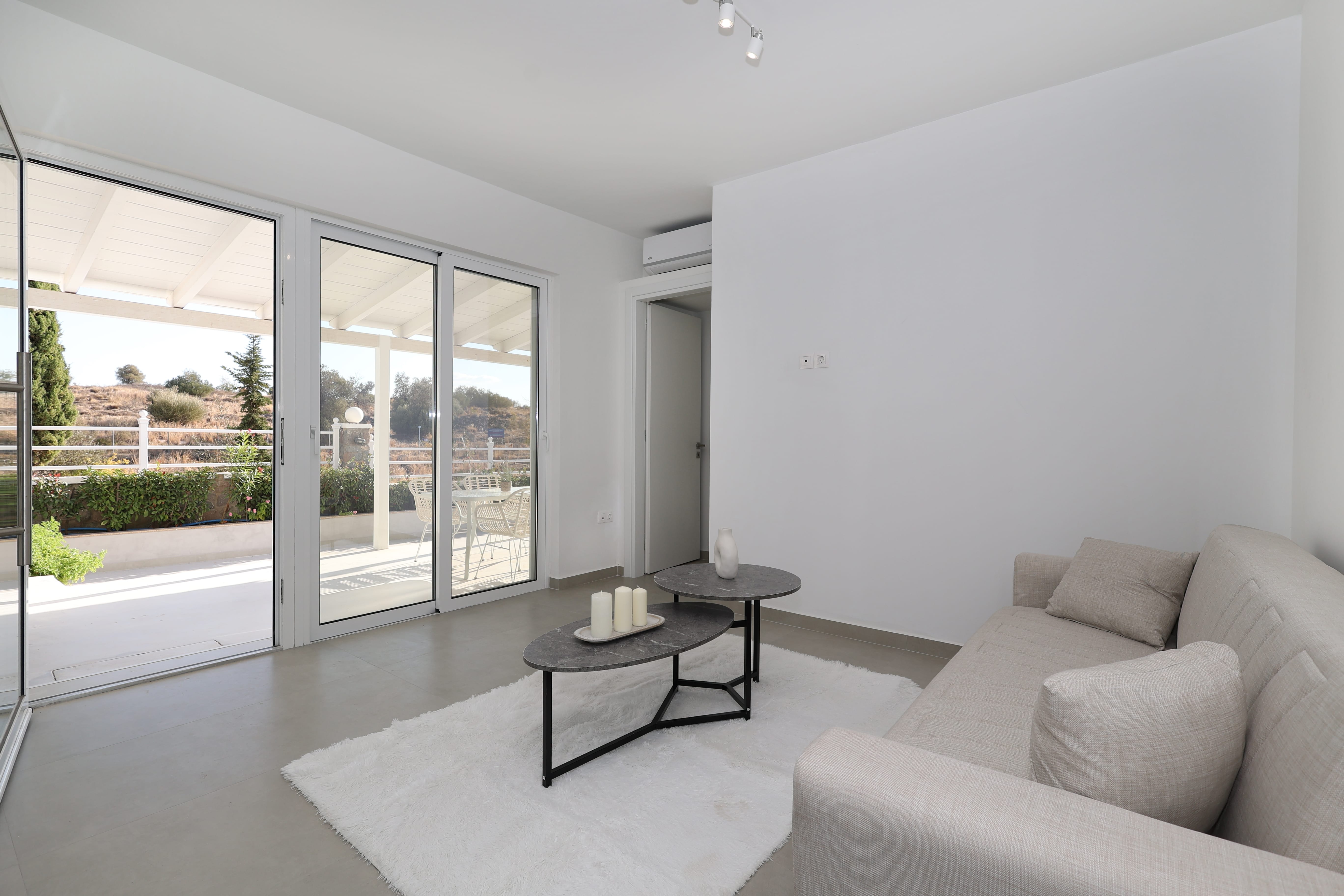 a living room with a glass wall