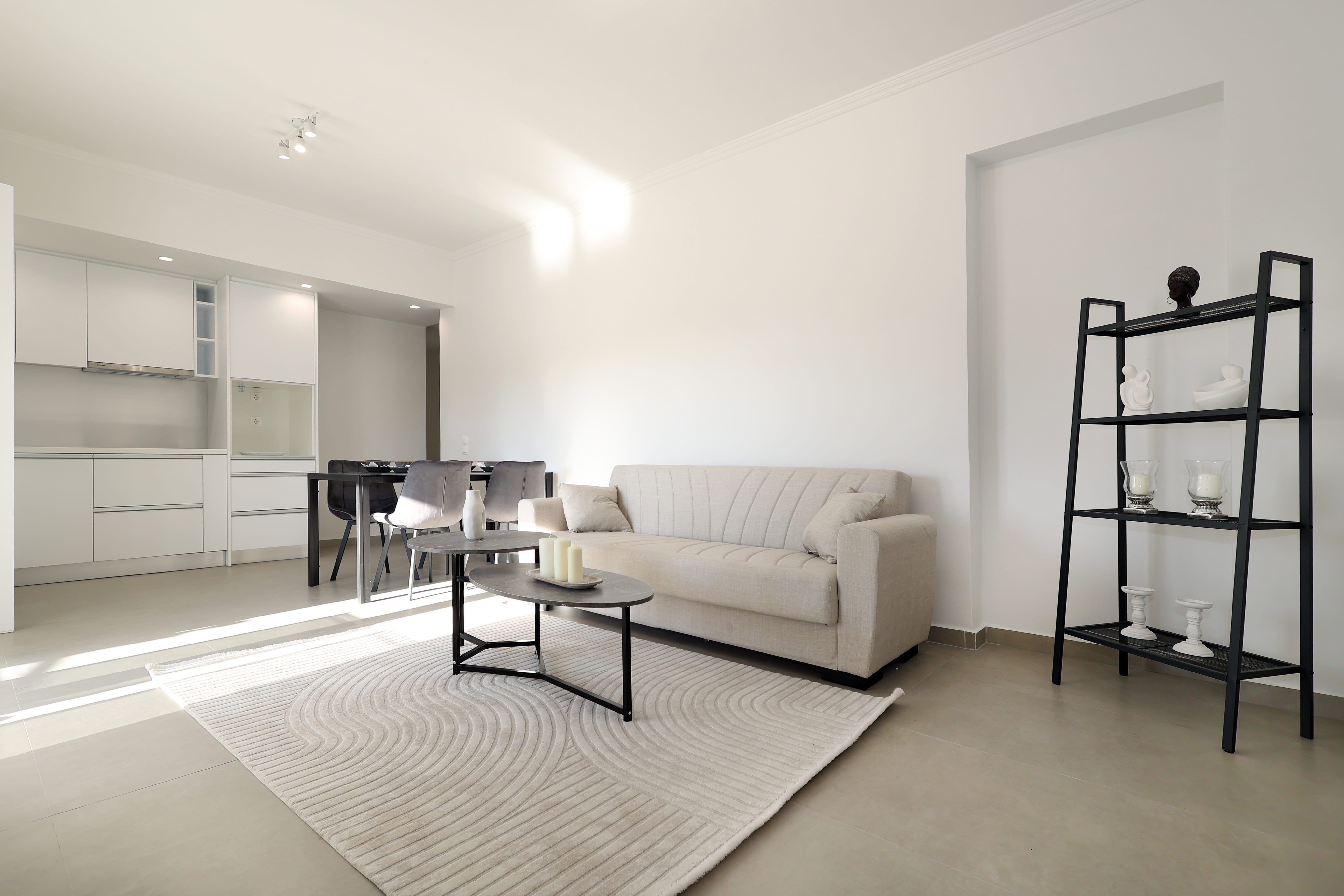 a living room with a white couch and a black ladder