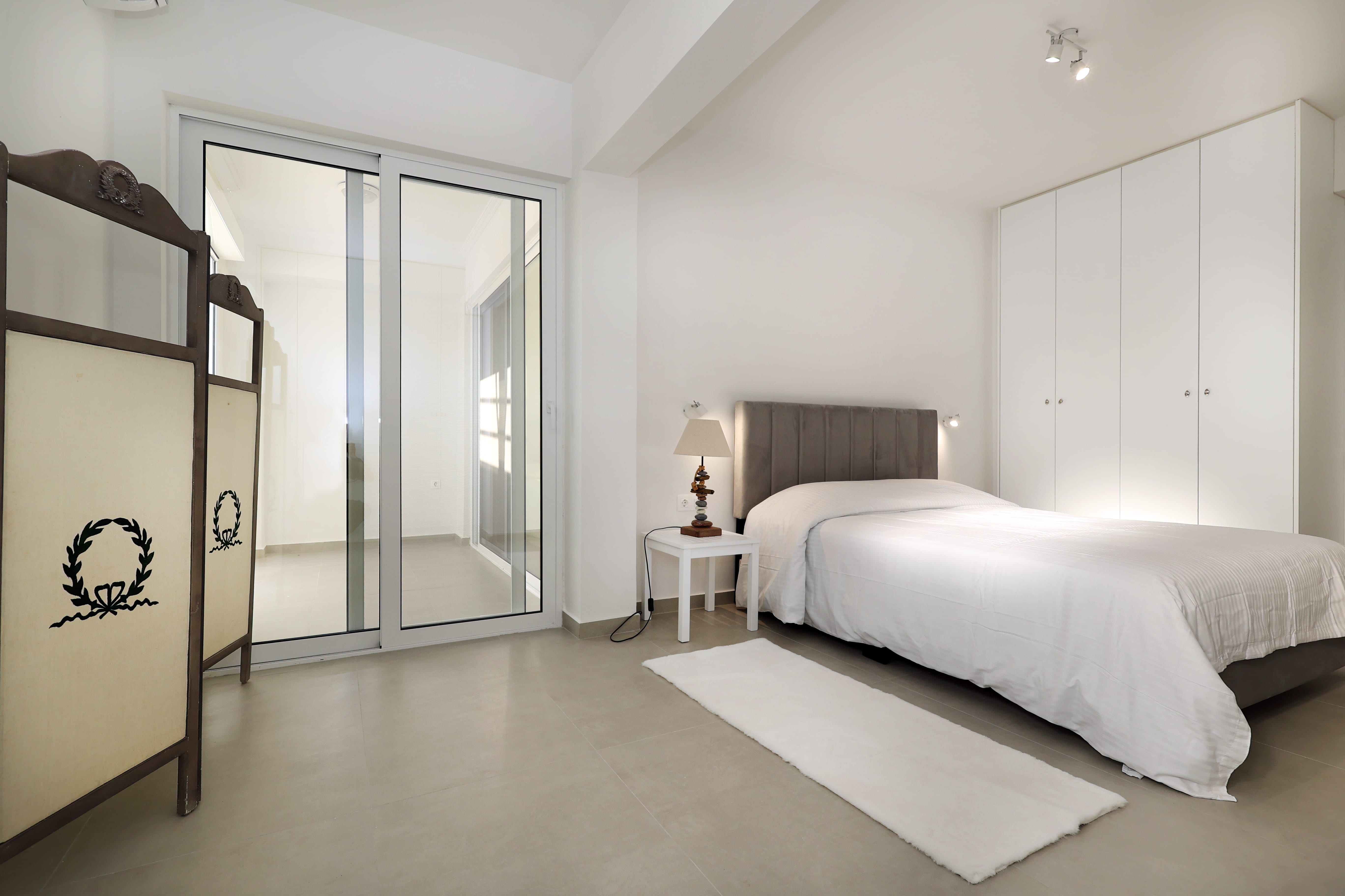 a bedroom with a large glass door