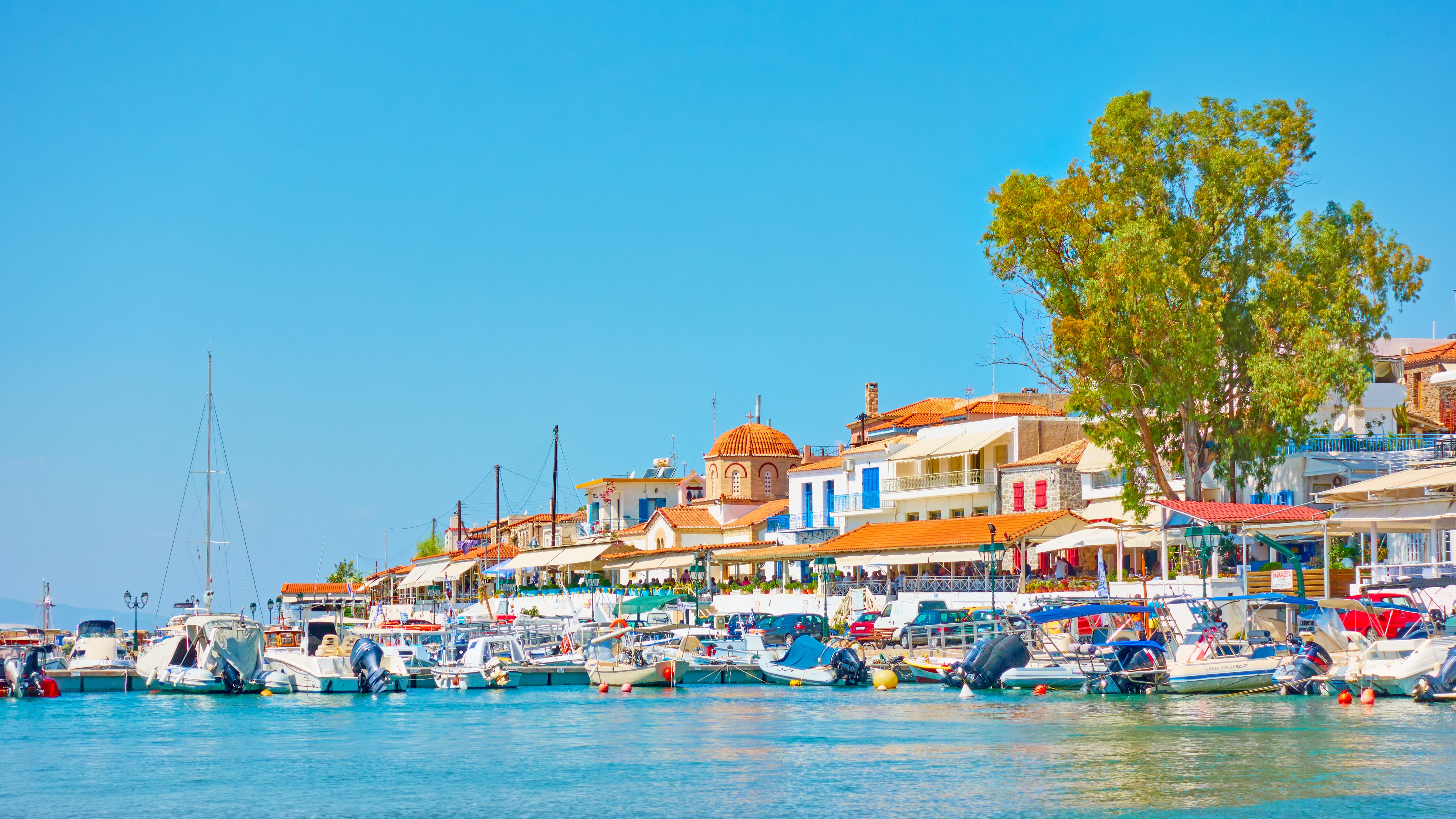 a body of water with boats and buildings along it