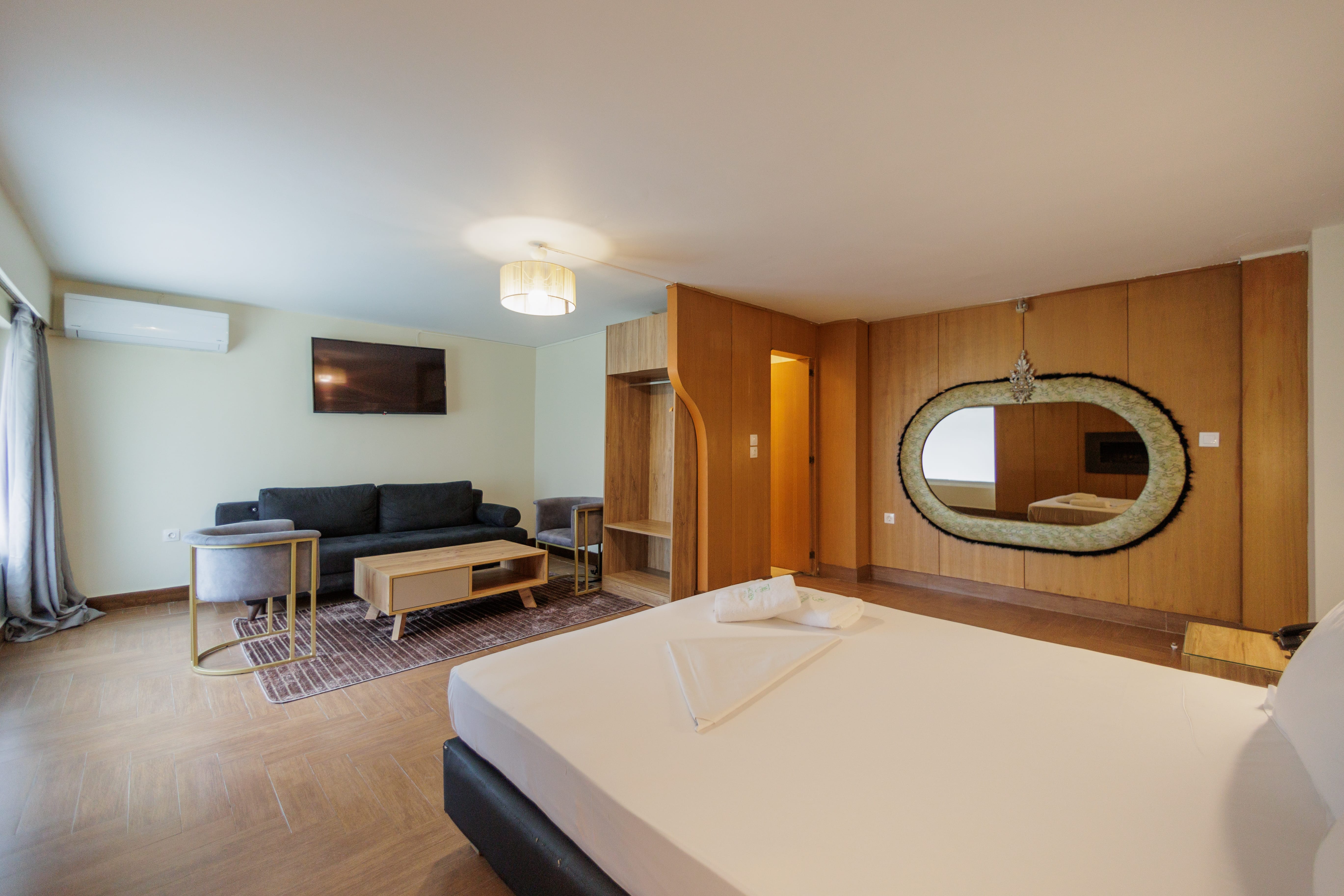 a large bedroom with a large mirror