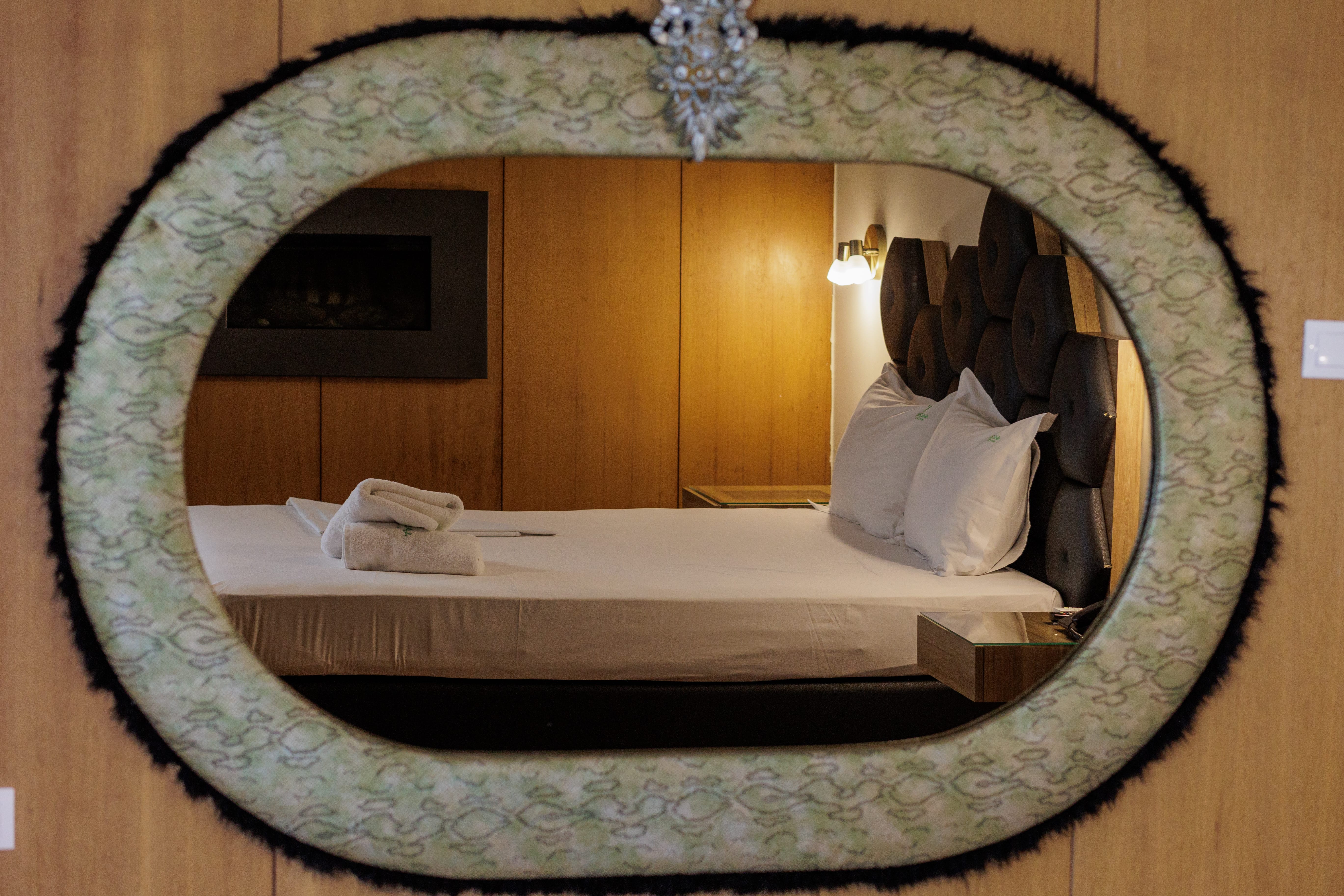 a mirror with a reflection of a person in it