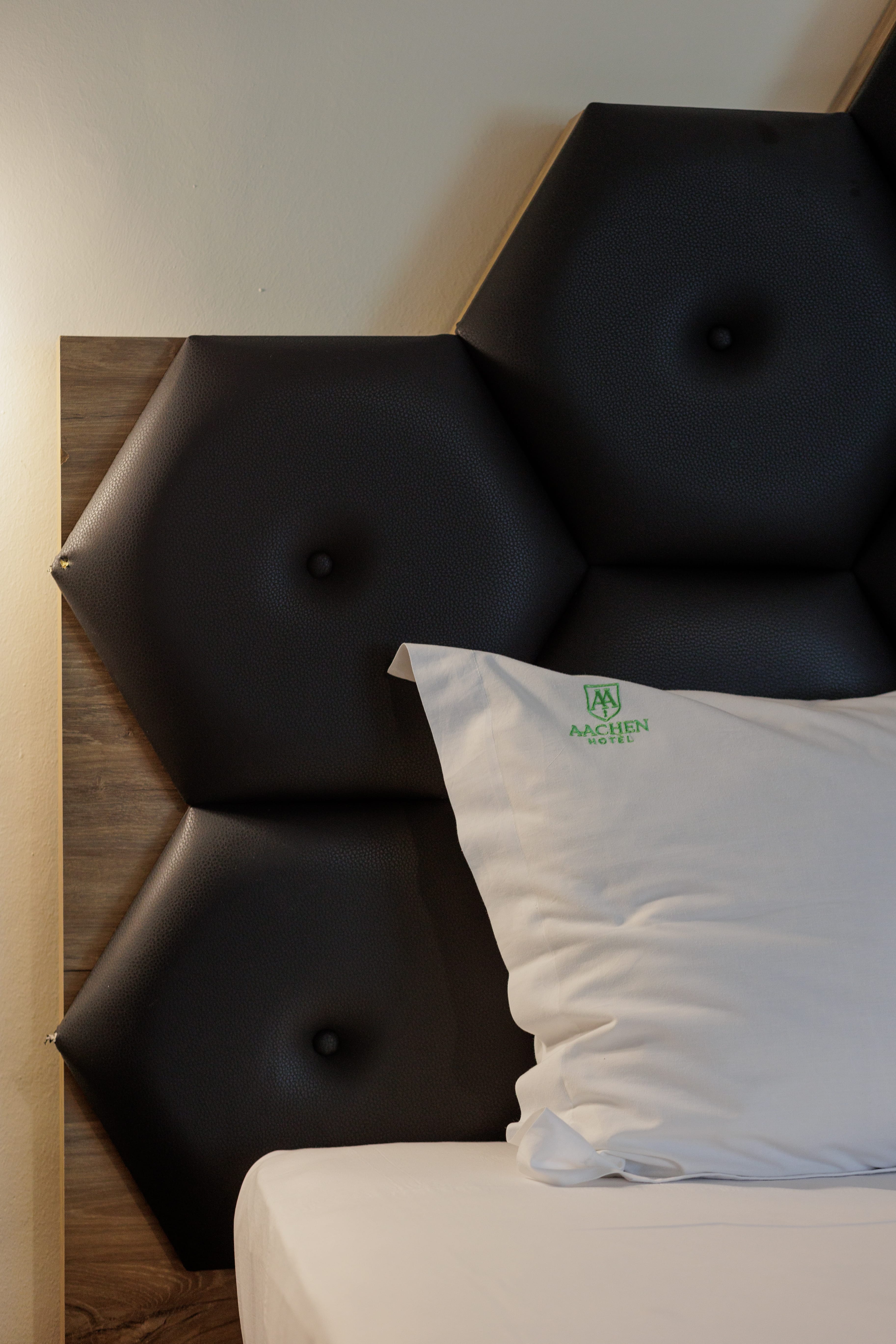 a black chair with a white pillow