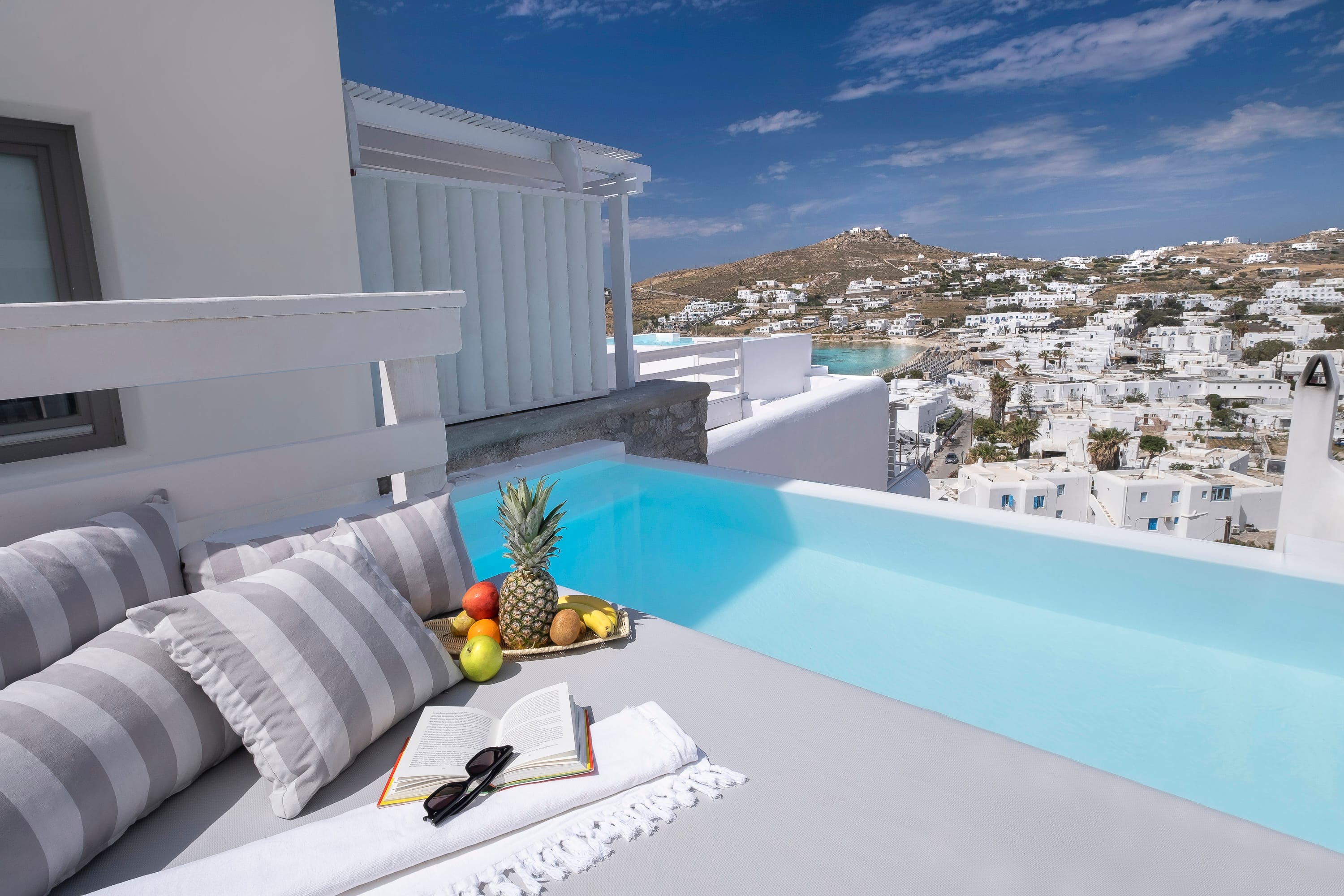 a pool with a view of a city and the ocean