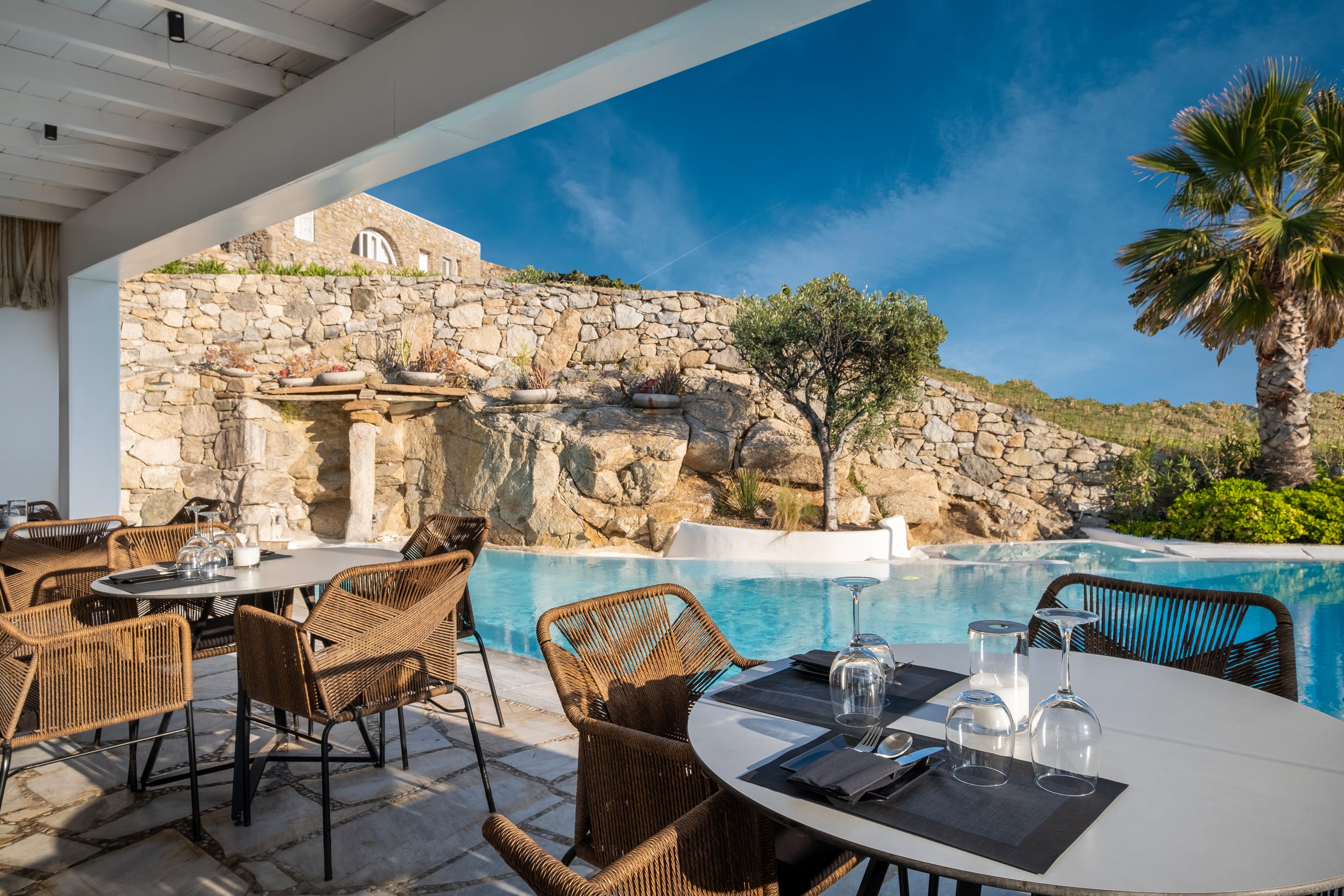 a pool with tables and chairs