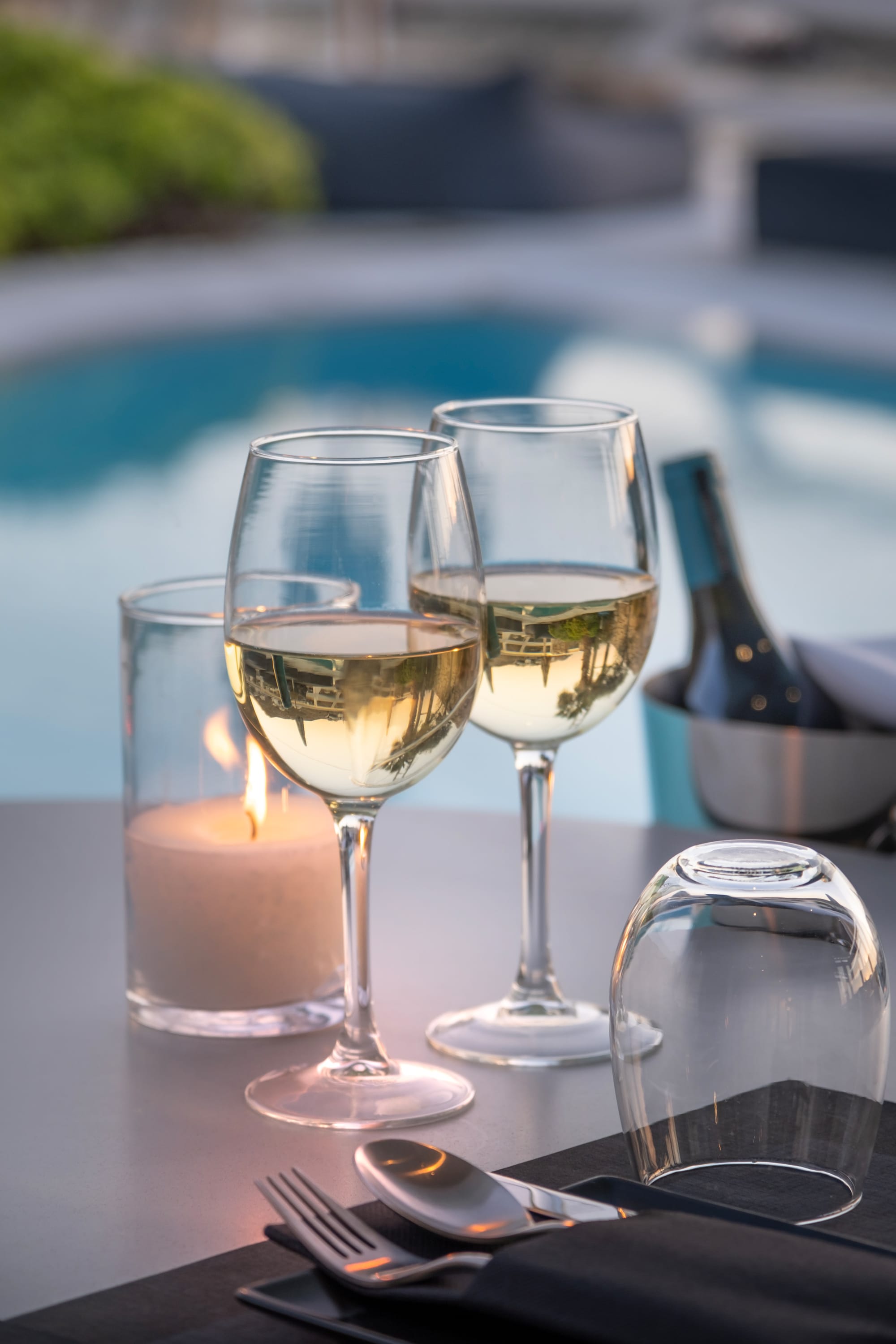 a group of wine glasses and a candle next to each other