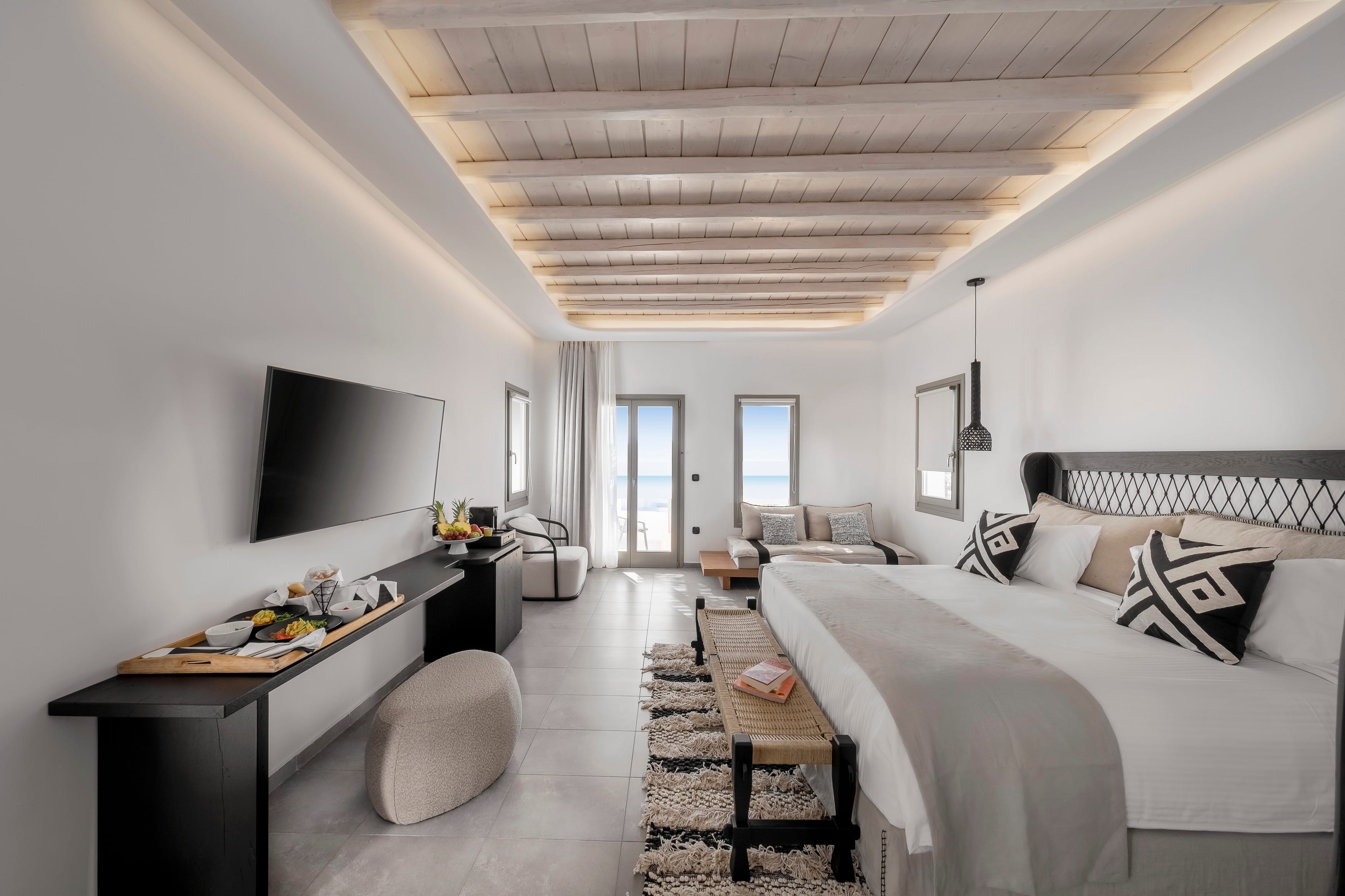 a bedroom with a bed and a tv