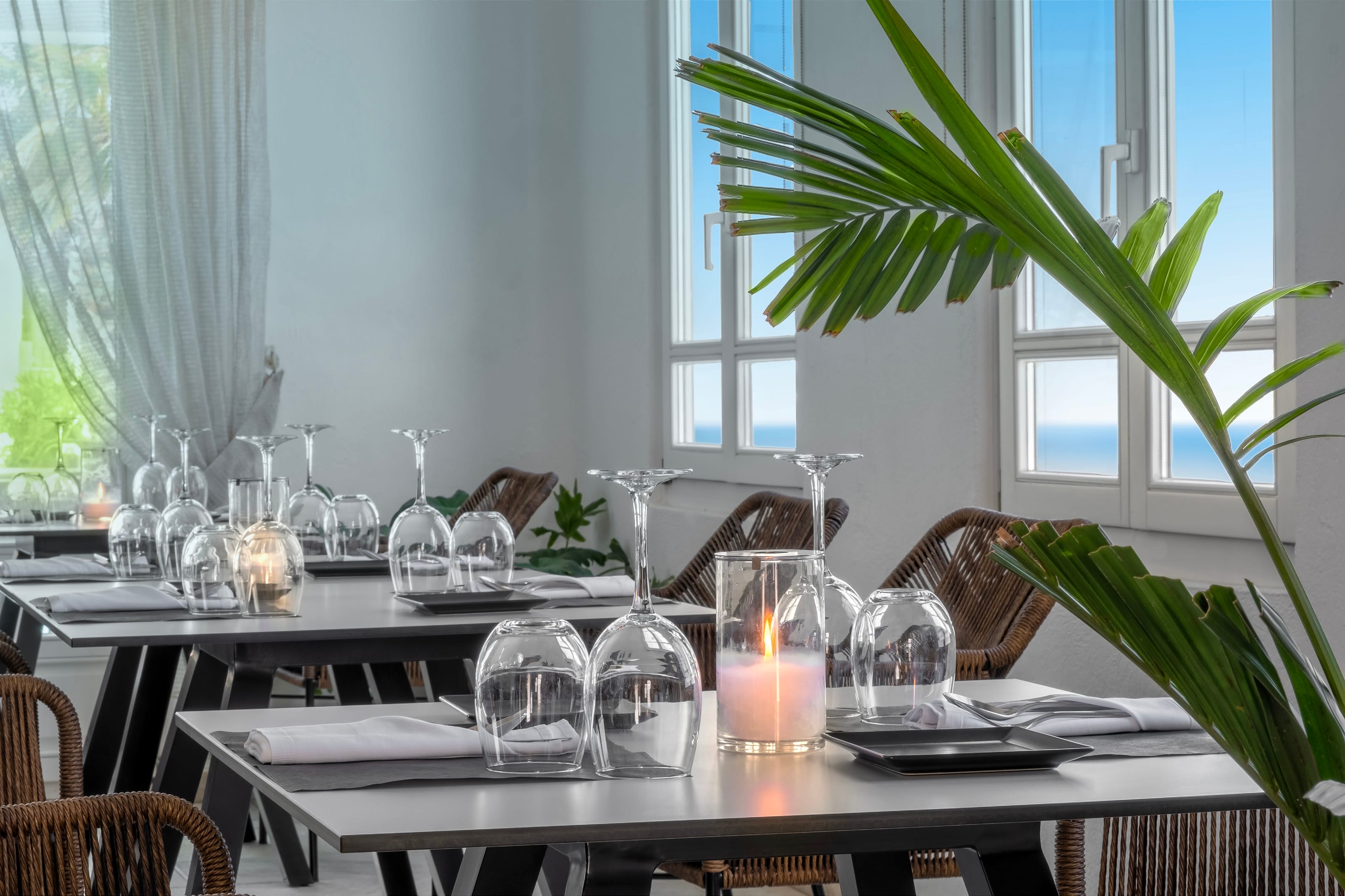 a table with glasses and candles on it