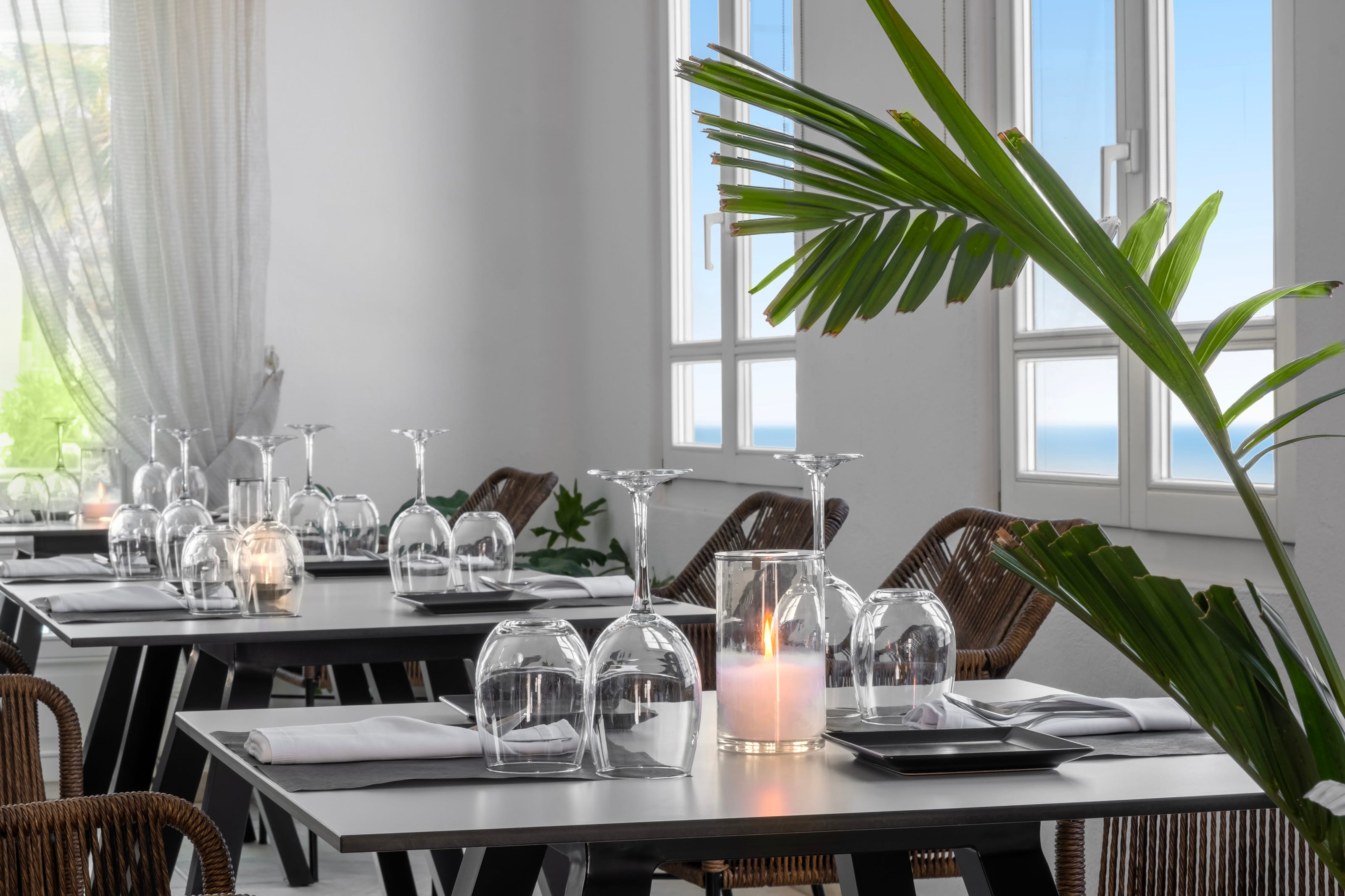 a table with glasses and candles on it