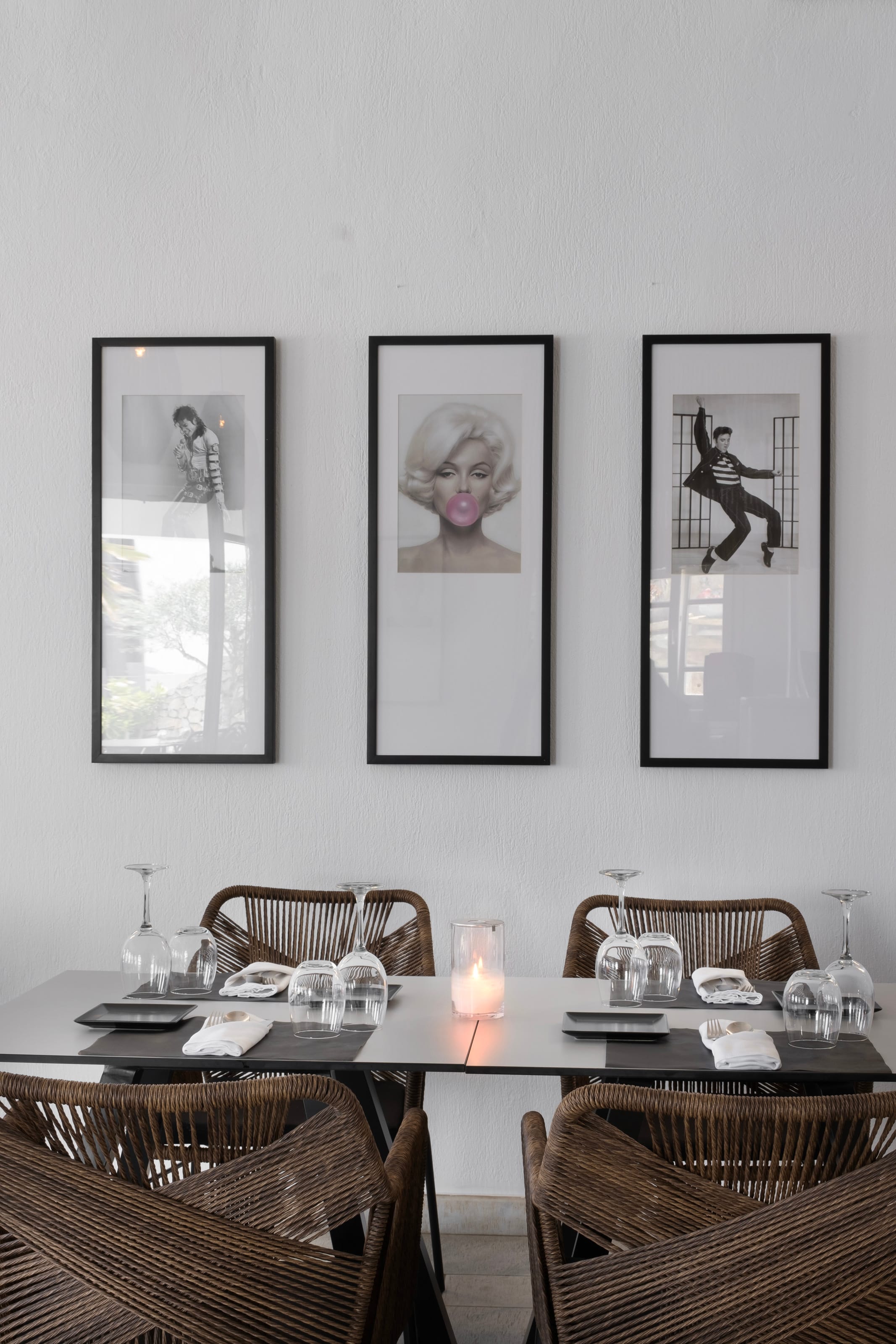 a table with a candle and pictures on the wall