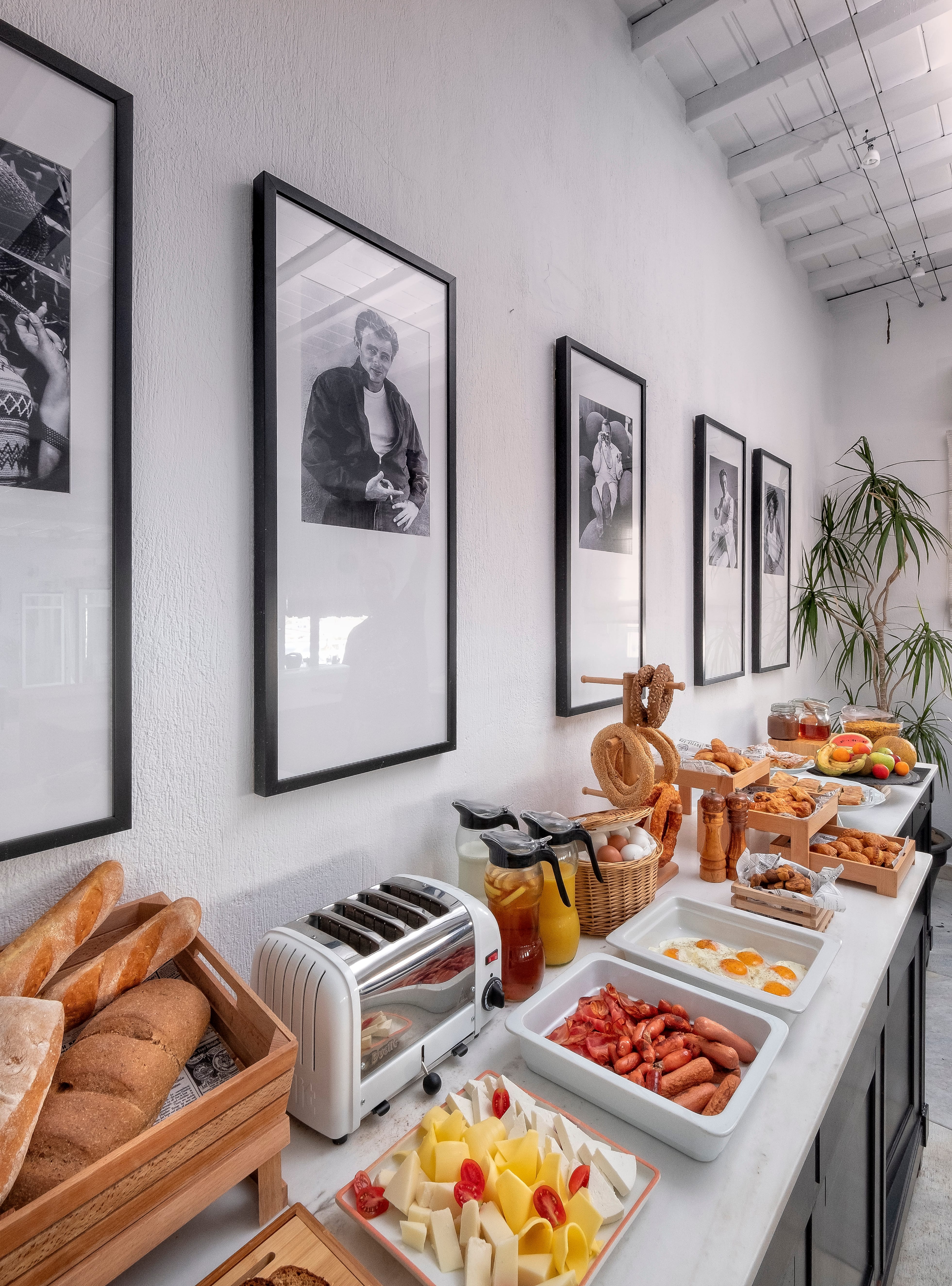 a kitchen with a table full of food and pictures on the wall