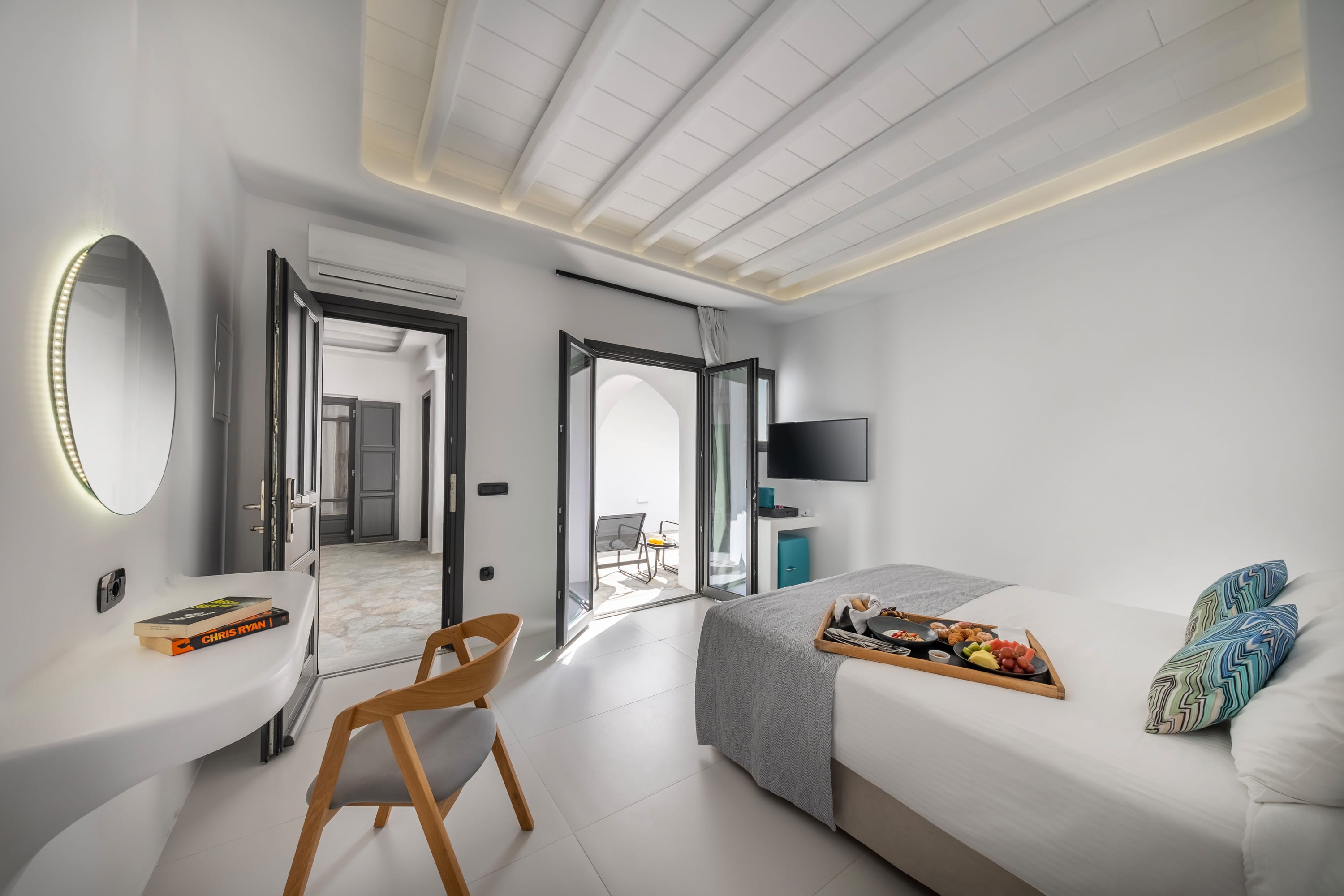 a bedroom with a bed and a tv