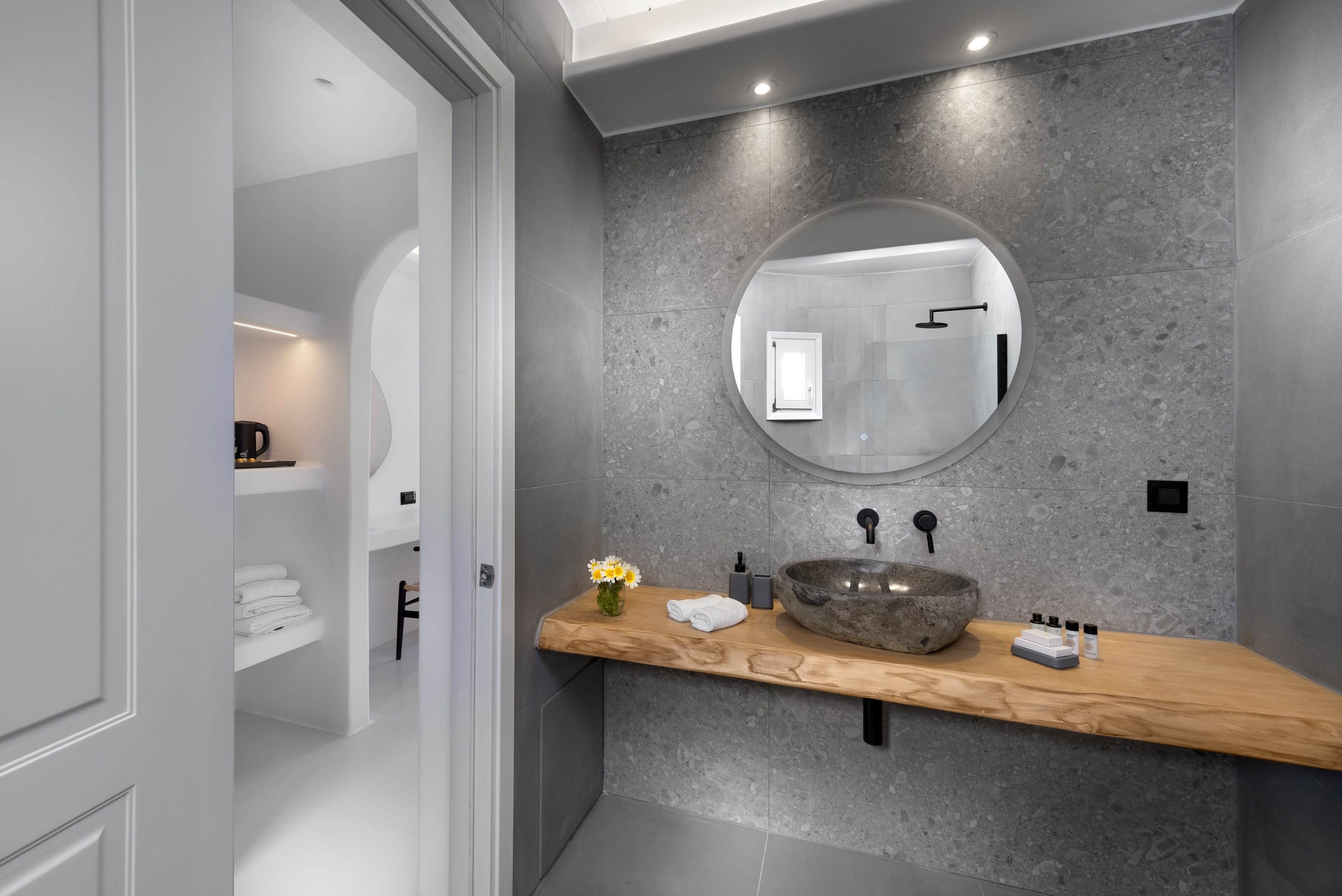 a bathroom with a round mirror