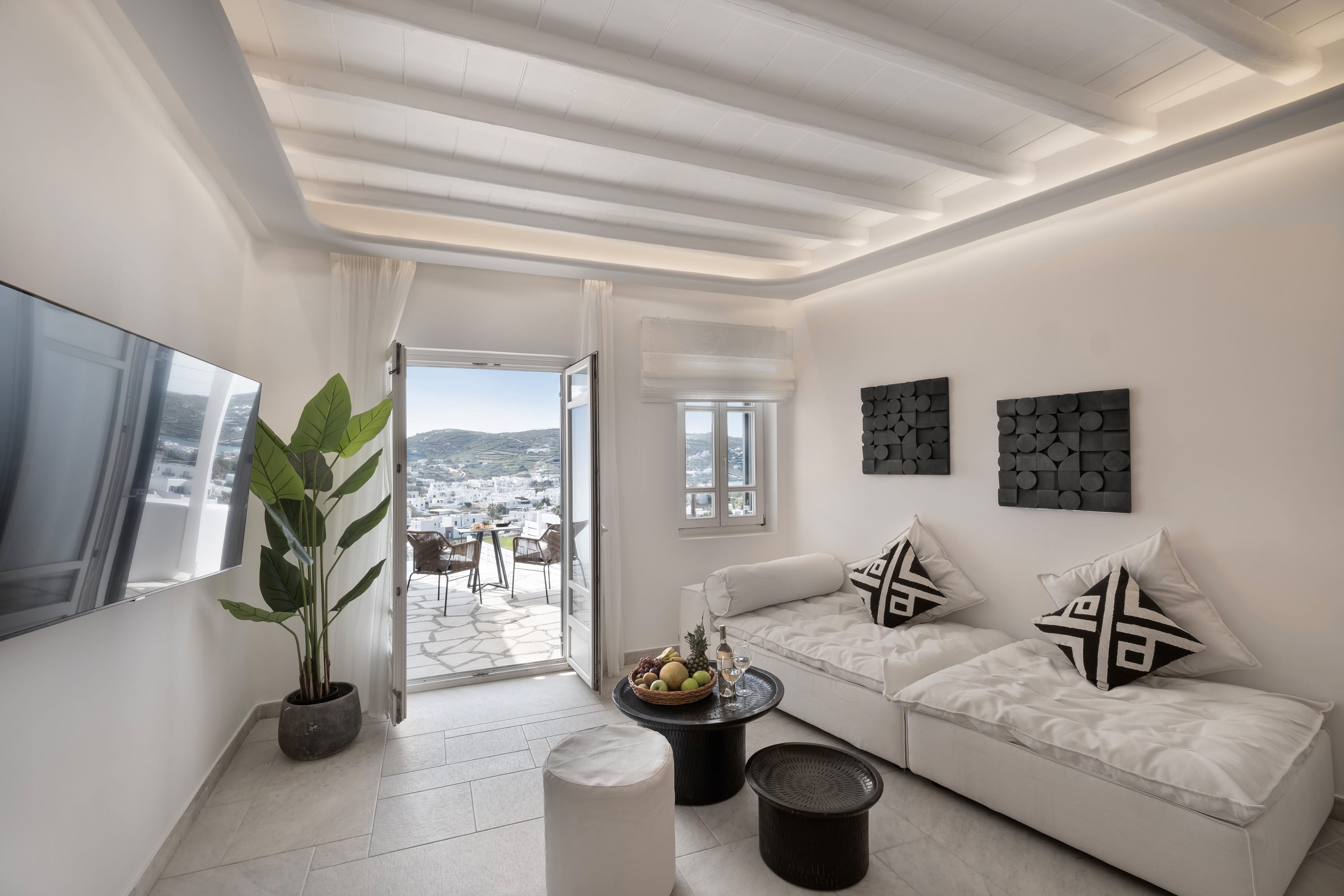 a living room with a white couch and a white table