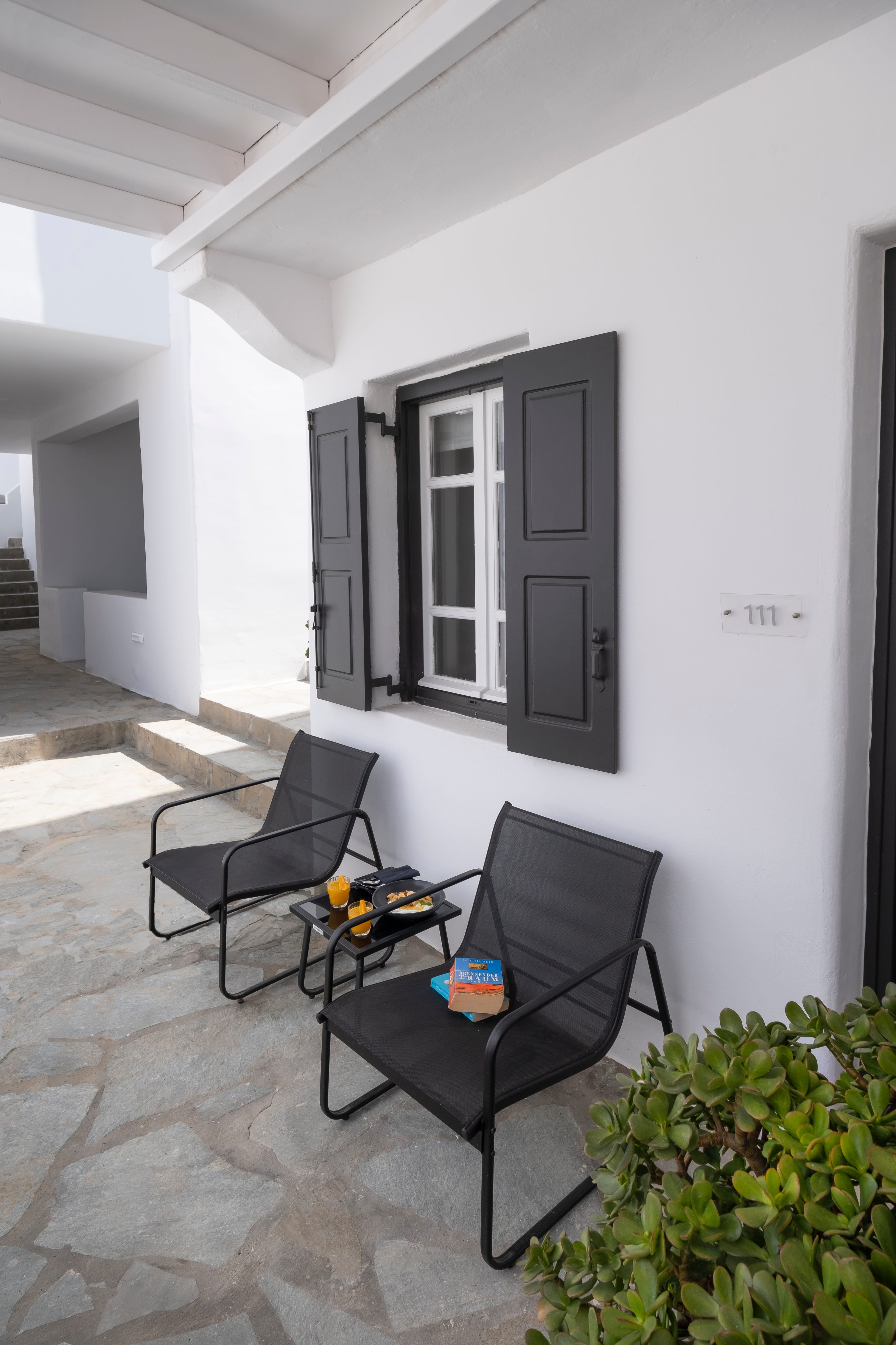 a chair and a table outside a house