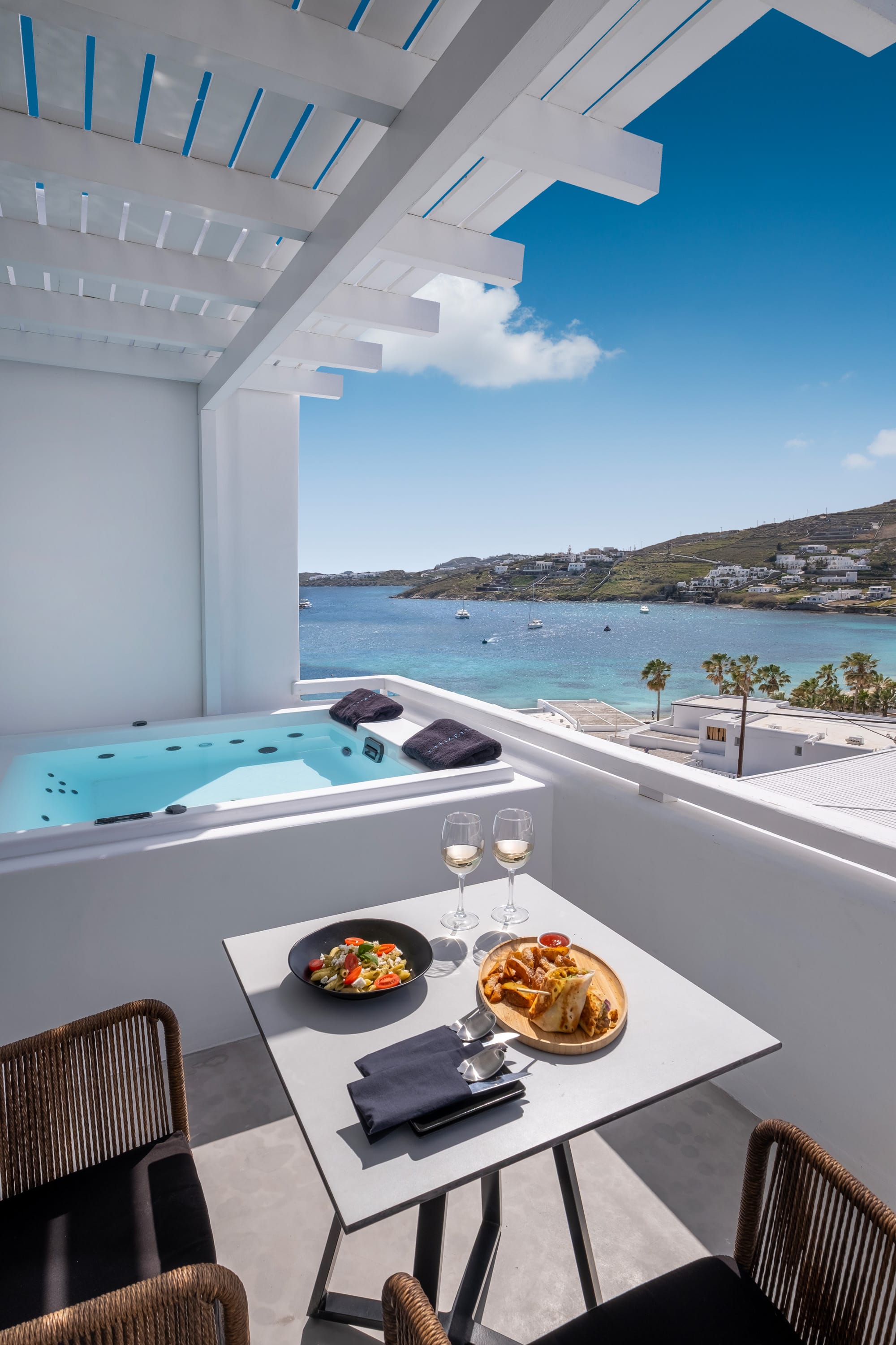 a table with food and drinks on it by a pool