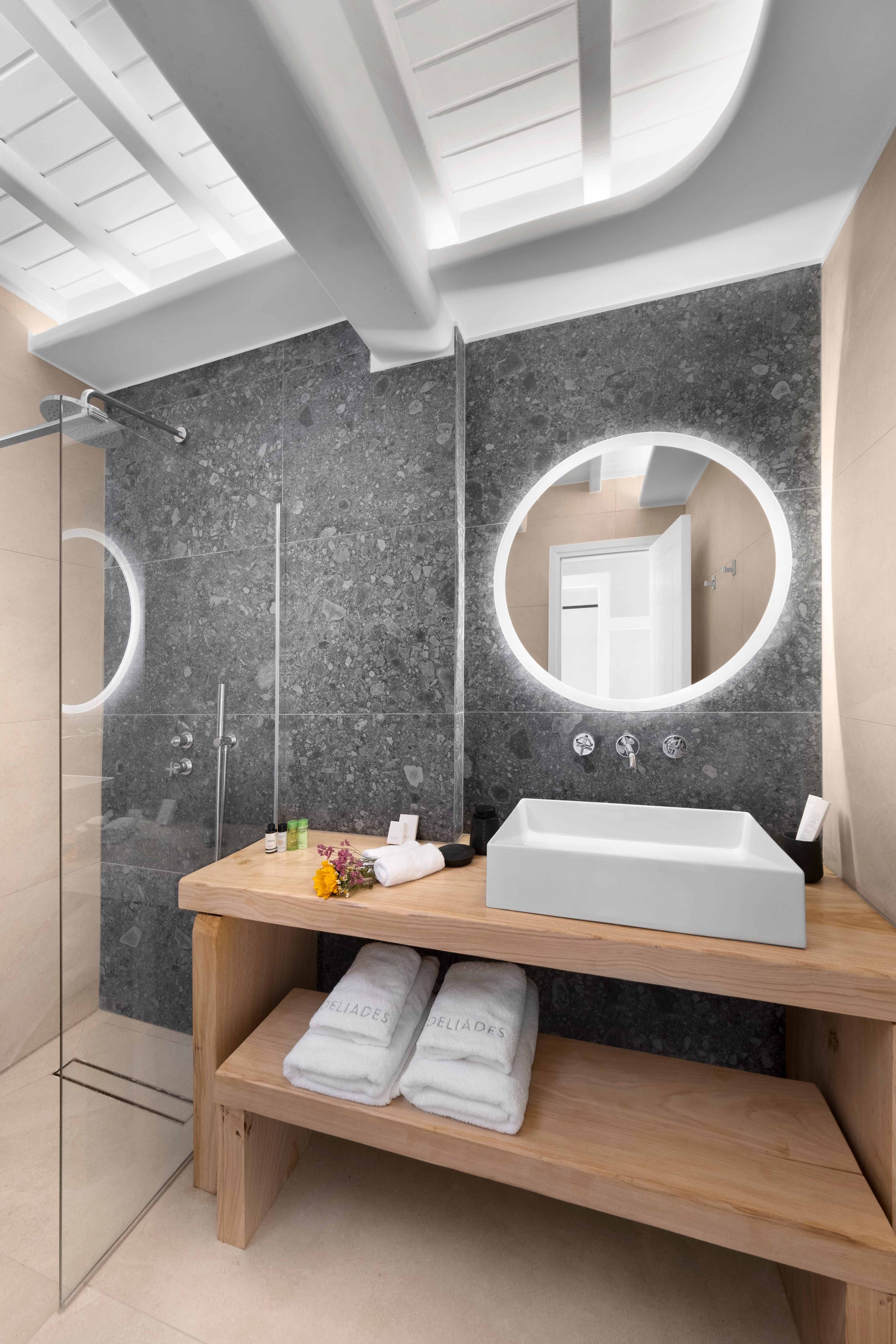 a bathroom with a round mirror