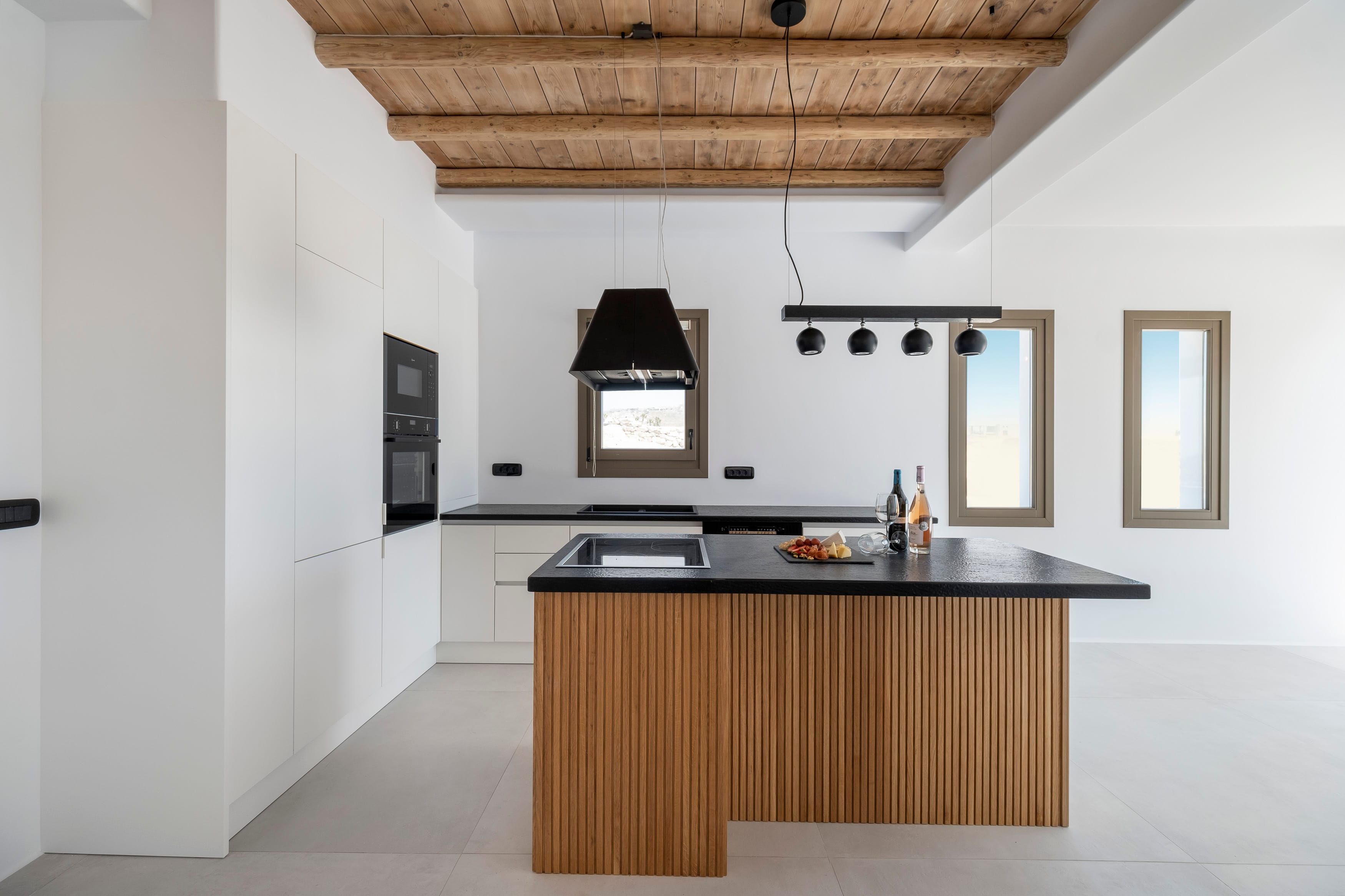 a kitchen with a bar and tv