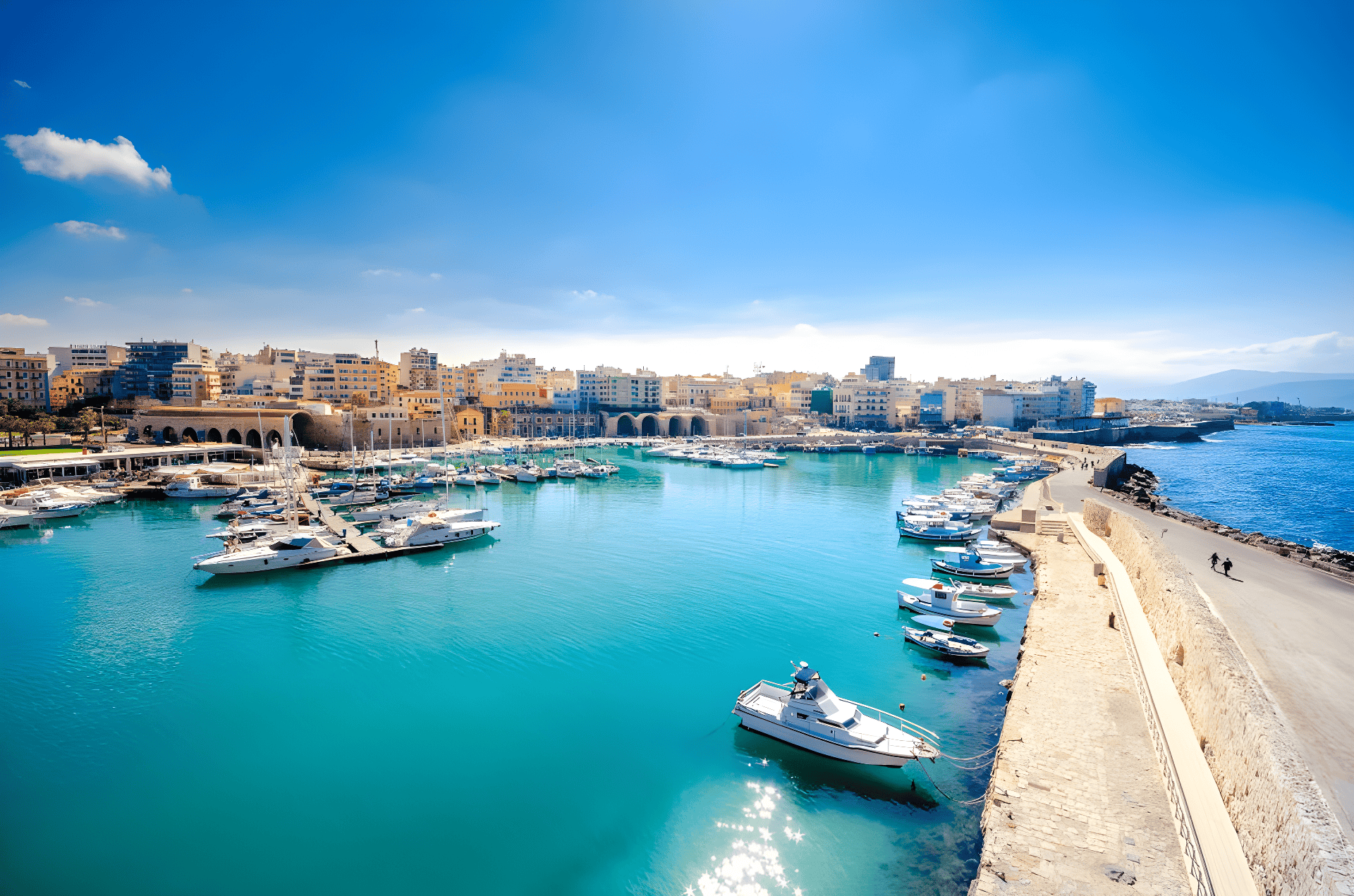 a body of water with boats in it and buildings in the back
