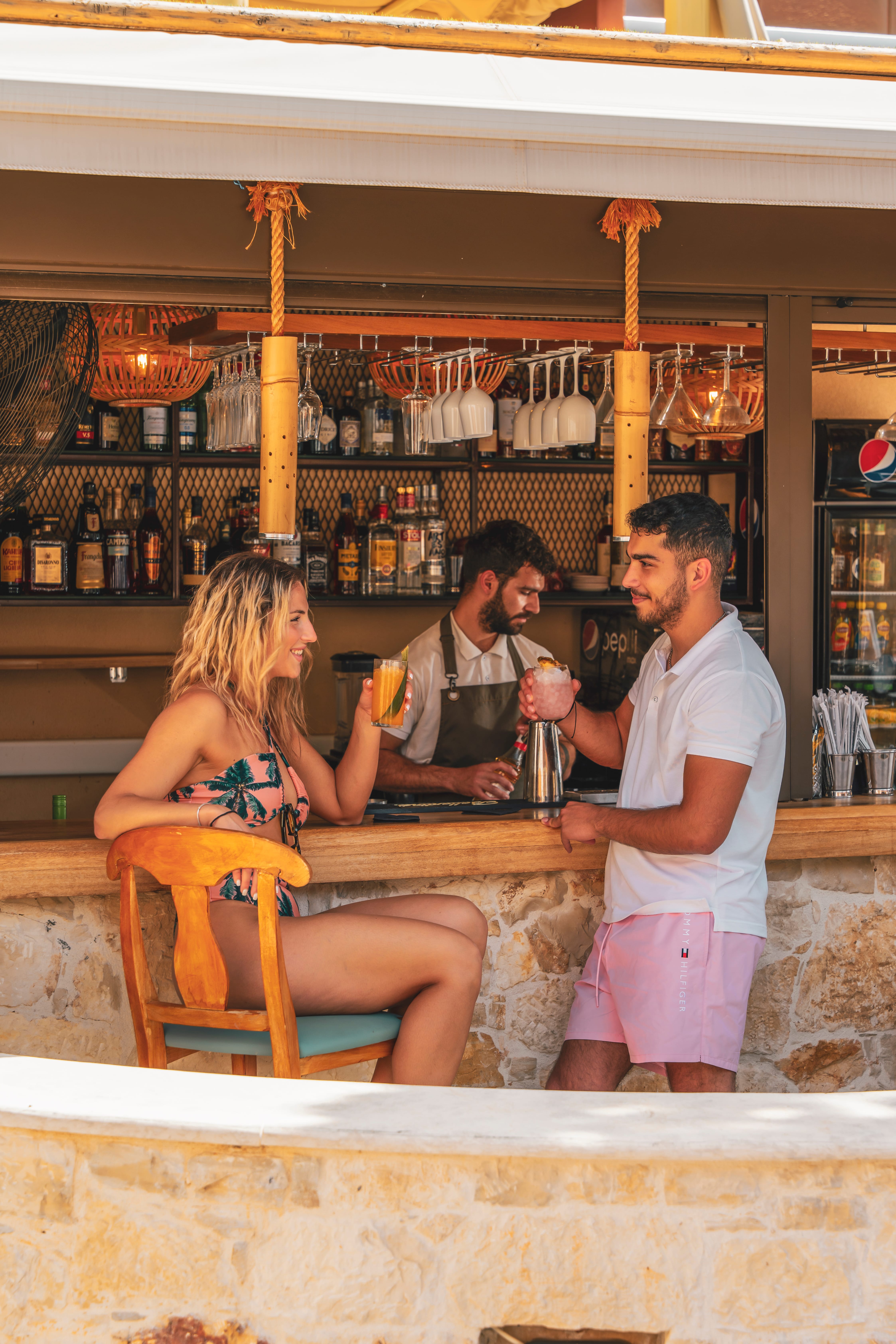 a group of people sitting at a bar