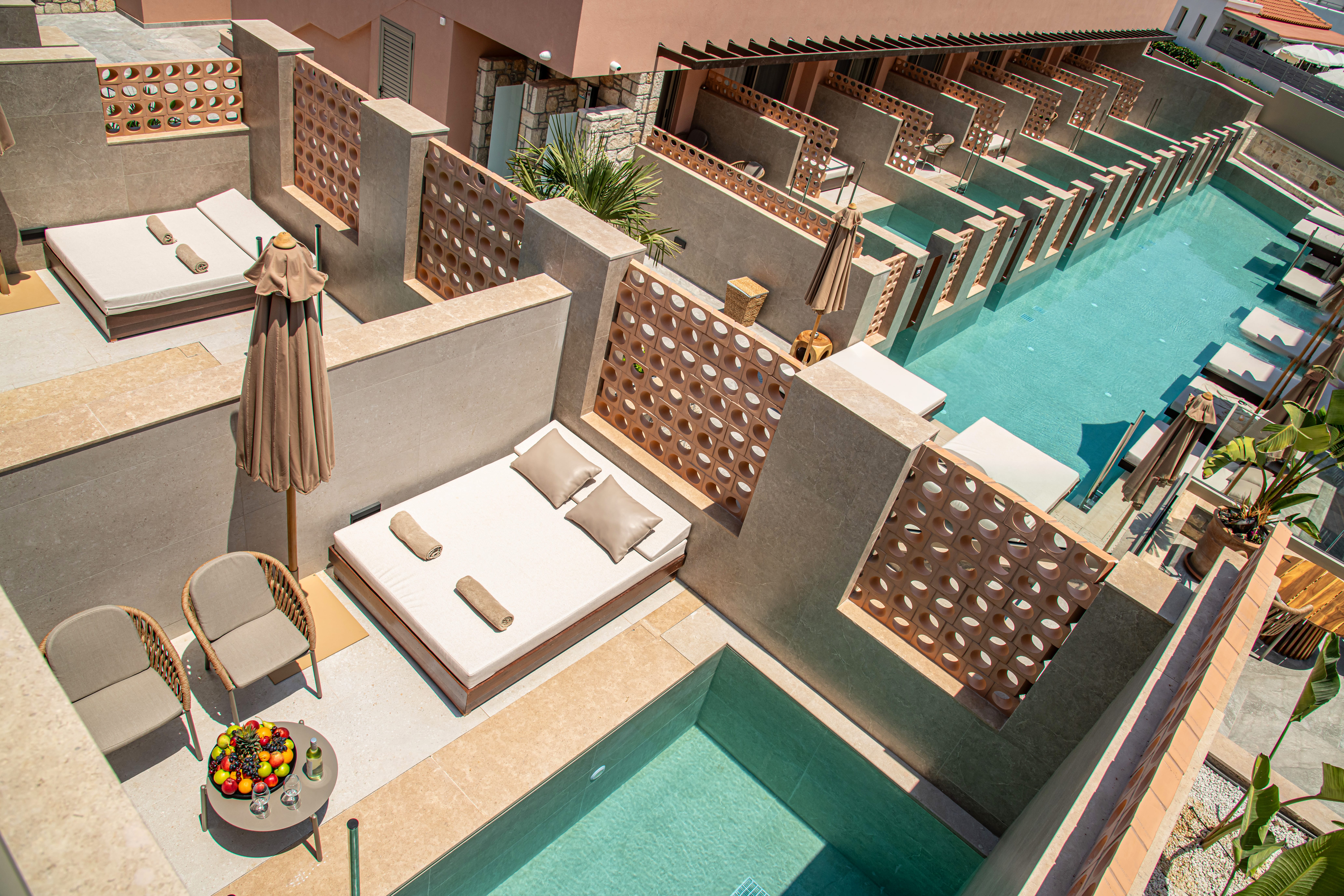 a pool with a bed and chairs