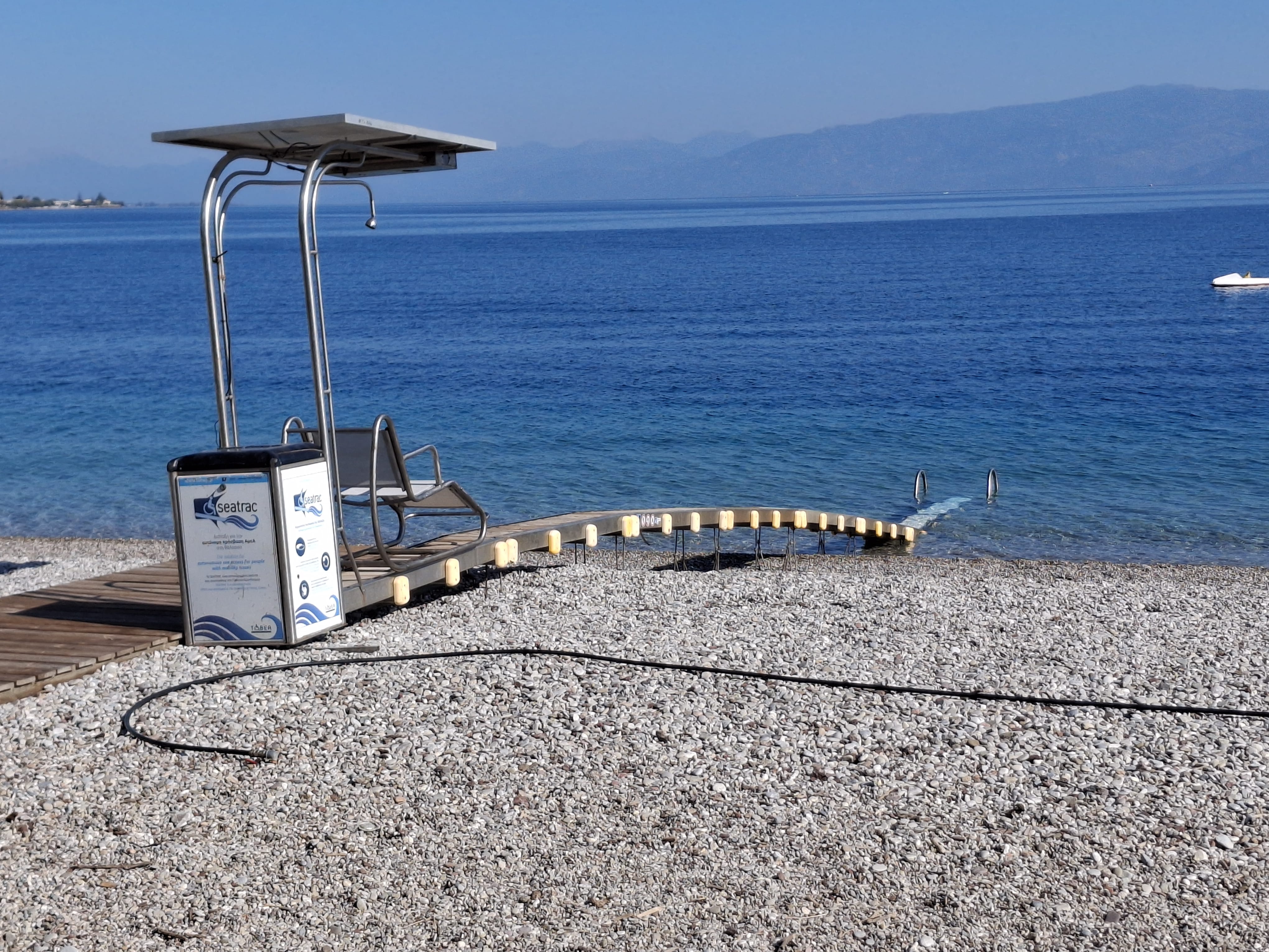 a white and black object on a concrete surface by a body of water