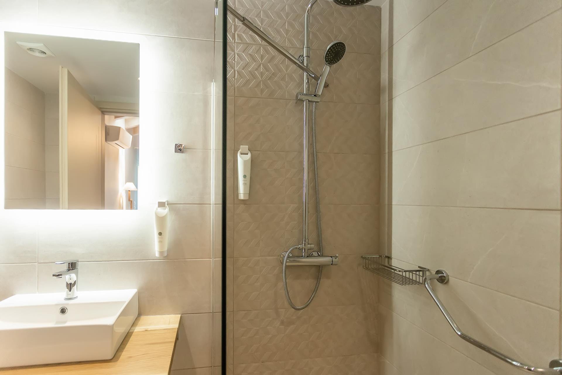 a bathroom with a shower unit and sink