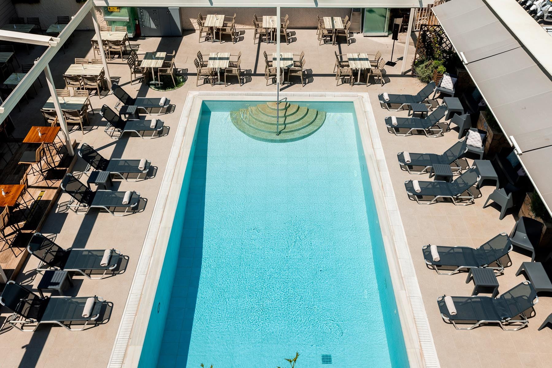 a pool with chairs around it