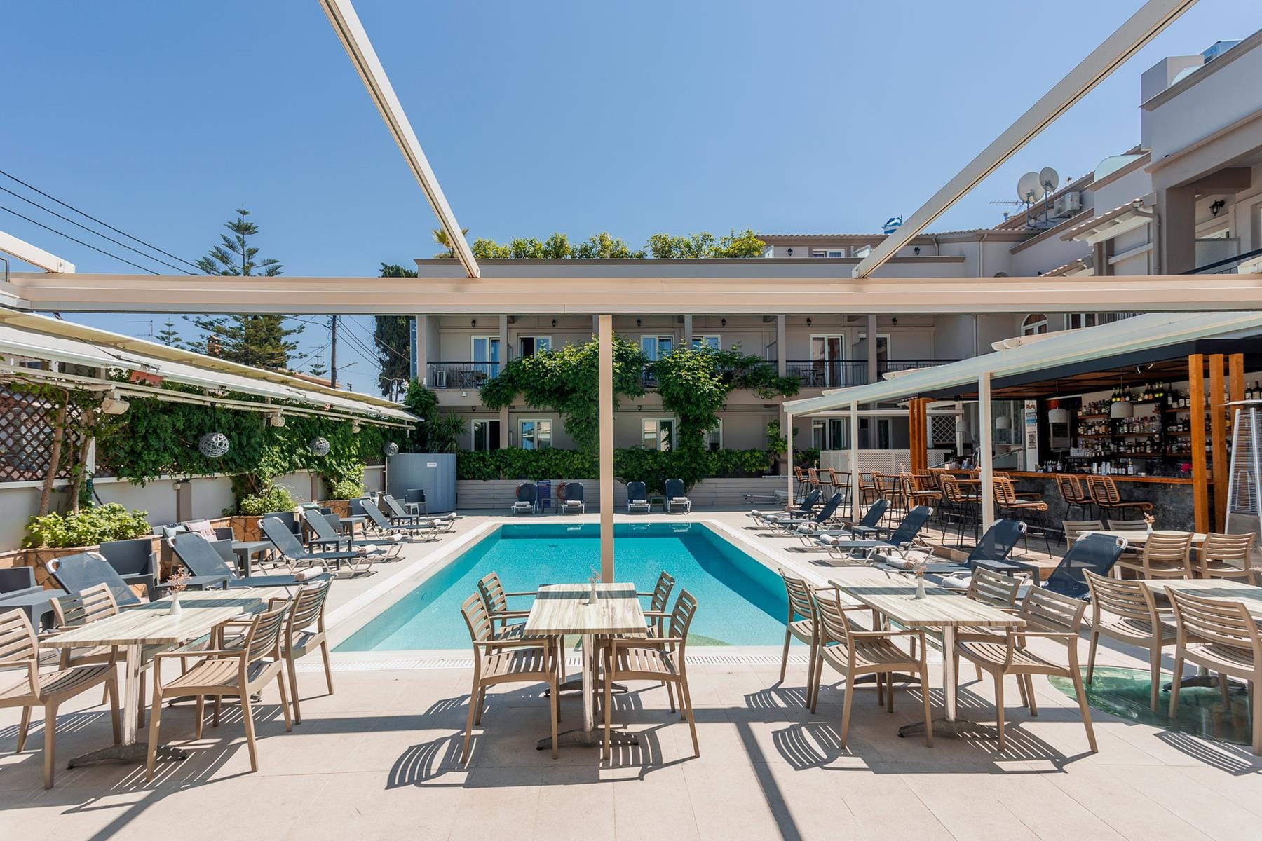 a pool with tables and chairs outside