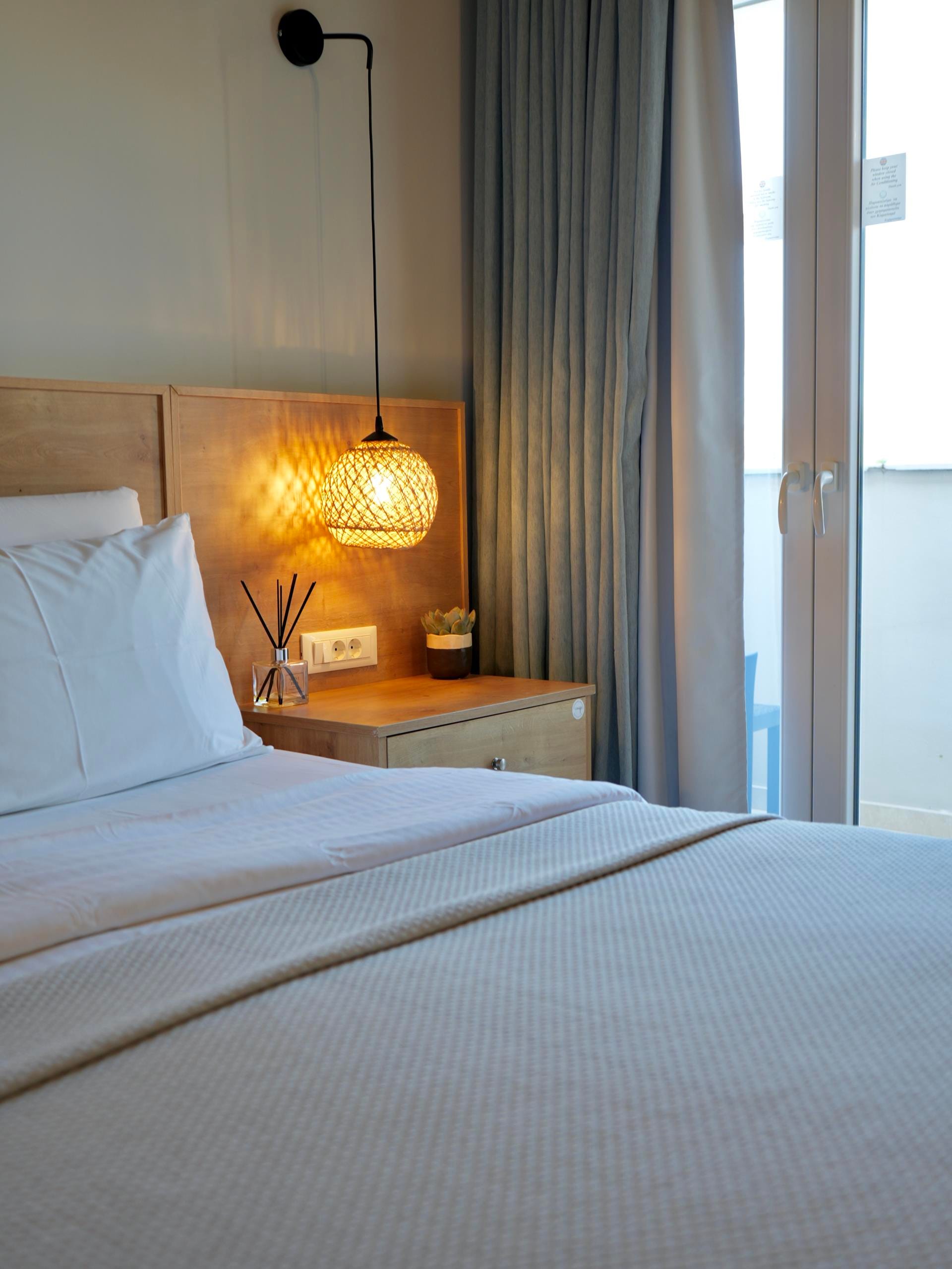 a bed with a lamp on the side