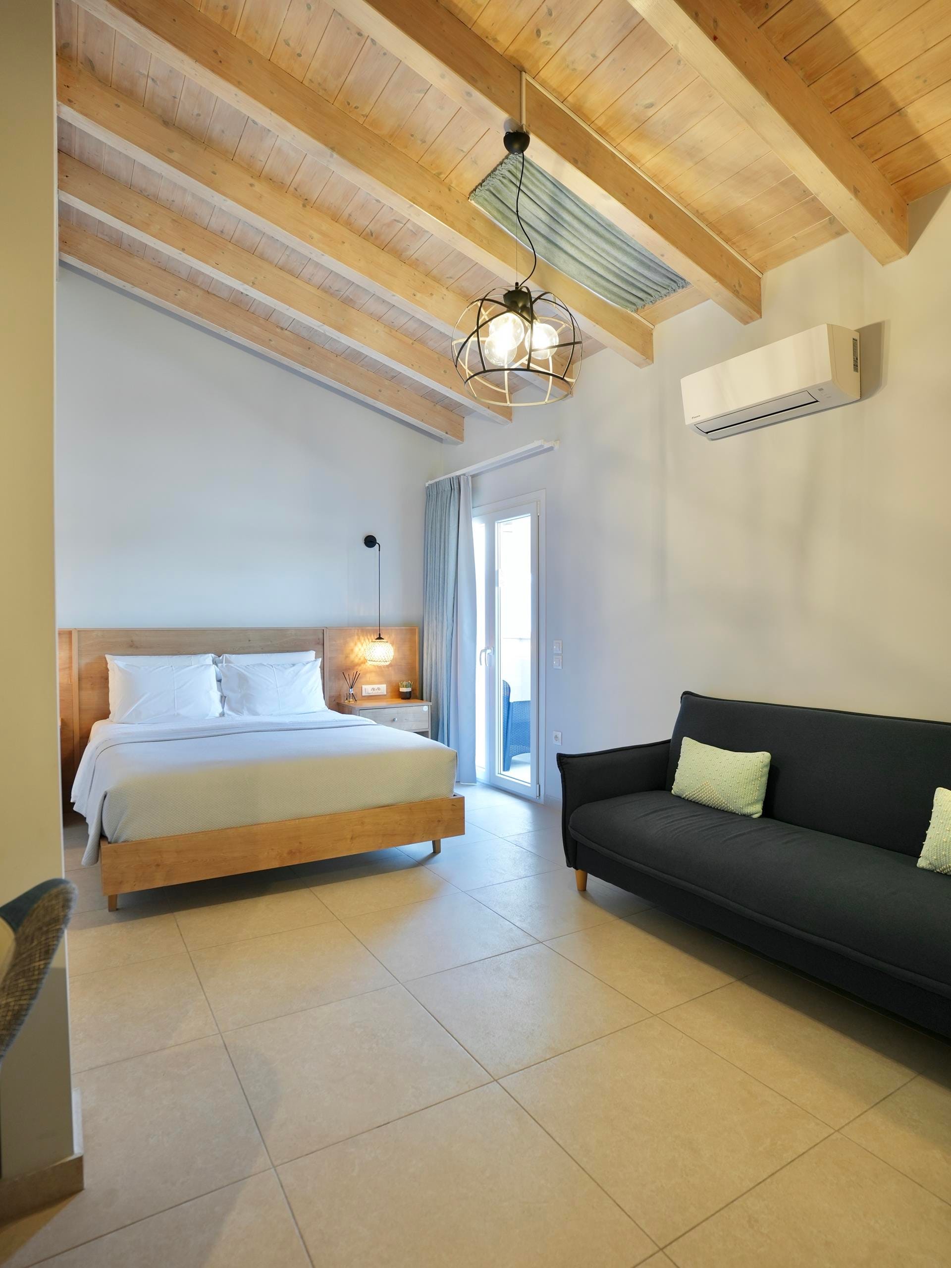 a bedroom with a bed and a couch