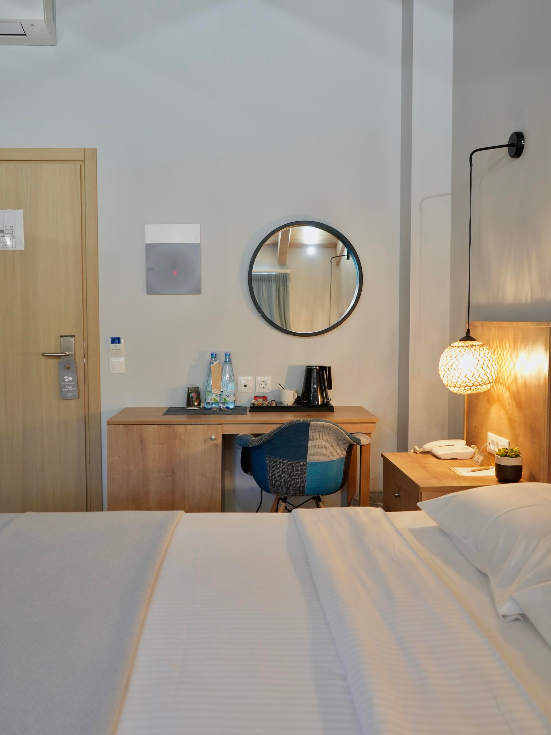 a bedroom with a mirror and a bed