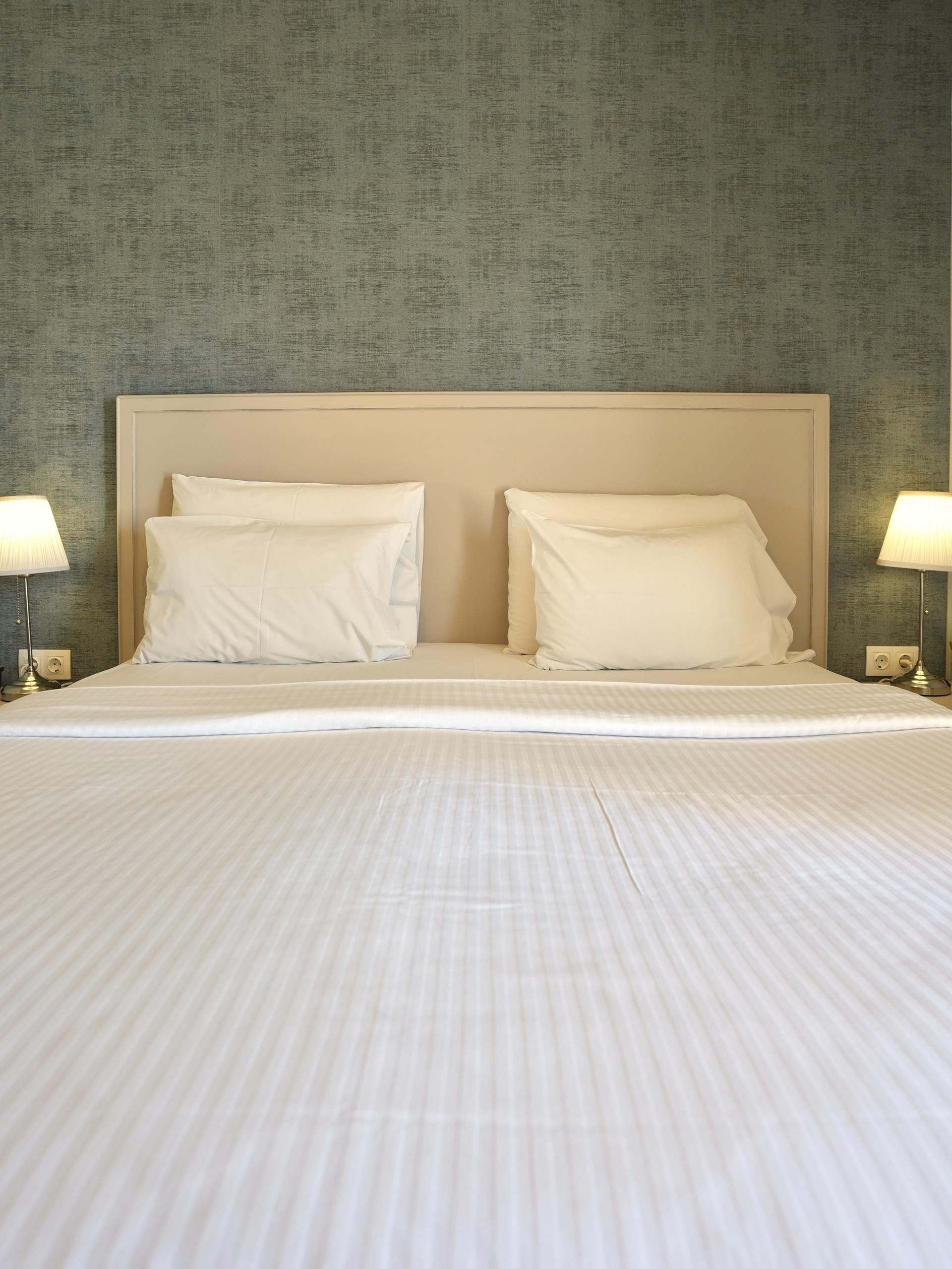 a bed with lamps on either side